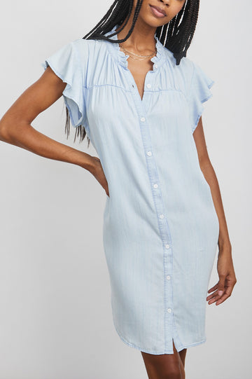 Kat Short Sleeve, Above the Knee Denim Dress with Buttons Down the Front, a Ruffled Collar and Flutter Sleeves in Light Vintage Colorway - Front View Featured on Model 