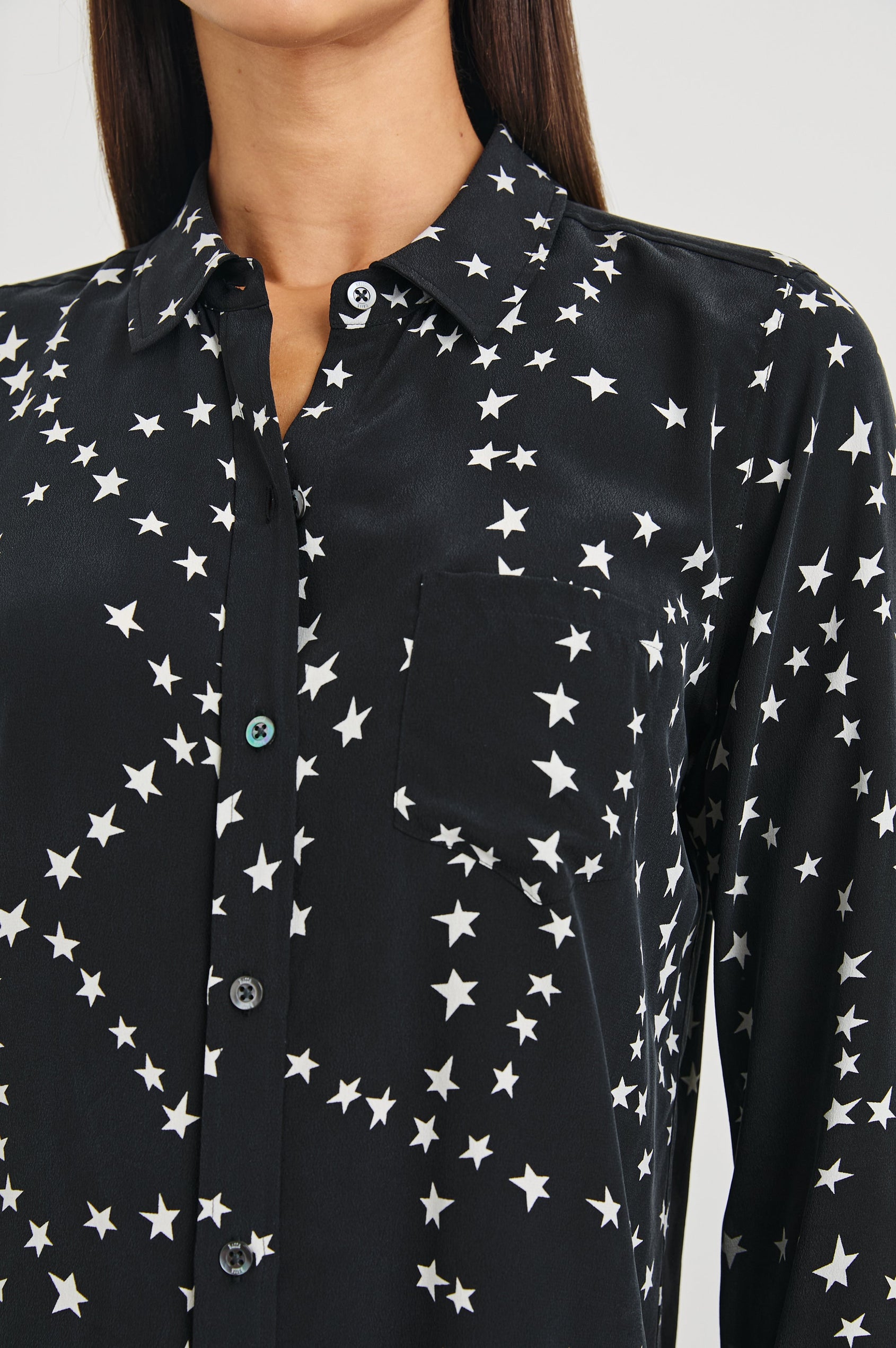 Kate Long Sleeve Button up with a Chest Patch Pocket in Black Star Chain Colorway, White Stars on Black - Front View Featured on Model