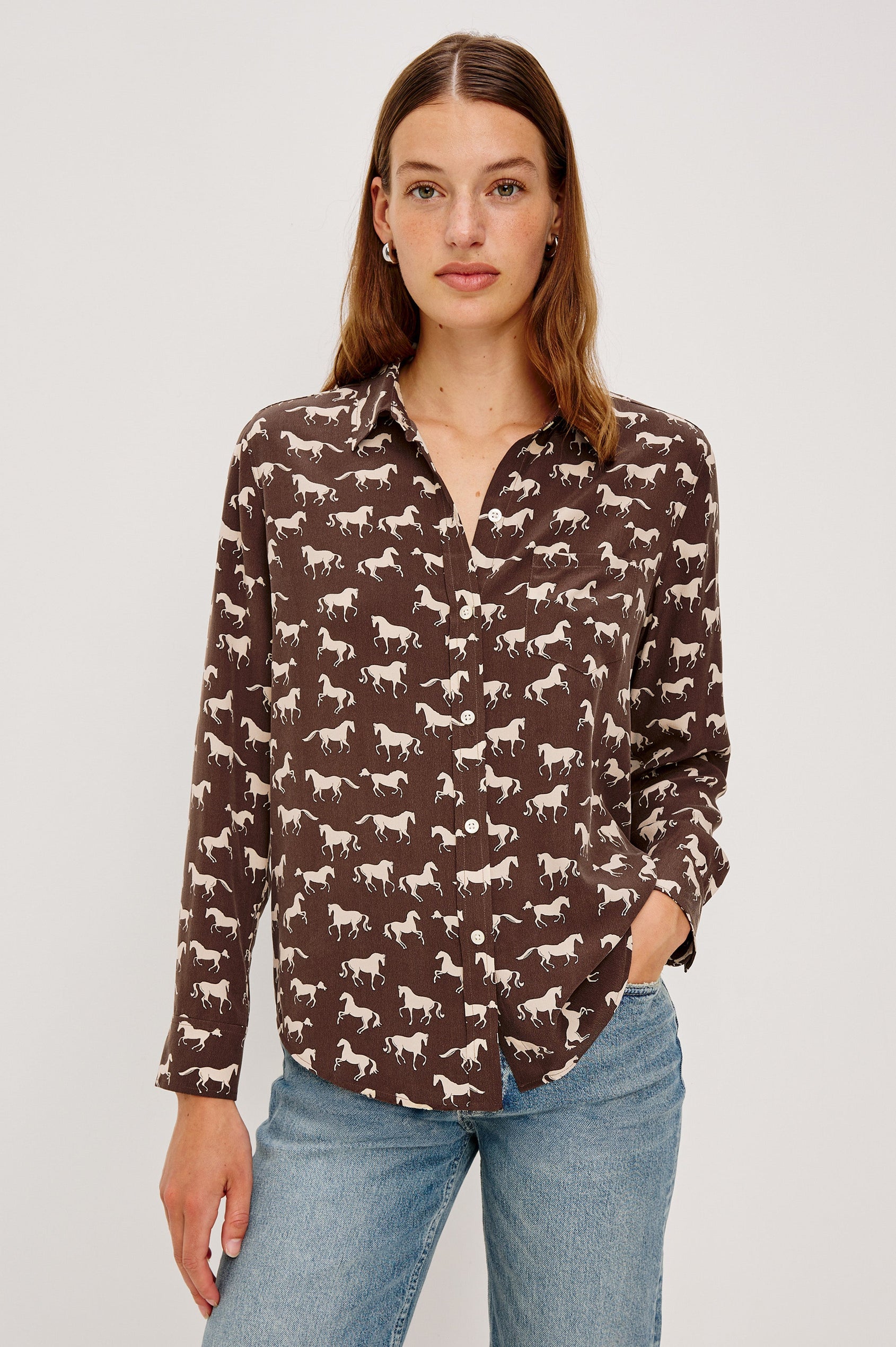 Washed silk button-down shirt in ivory with a horse print. The shirt has a soft drape and classic collar for a polished look. Front View on Model.