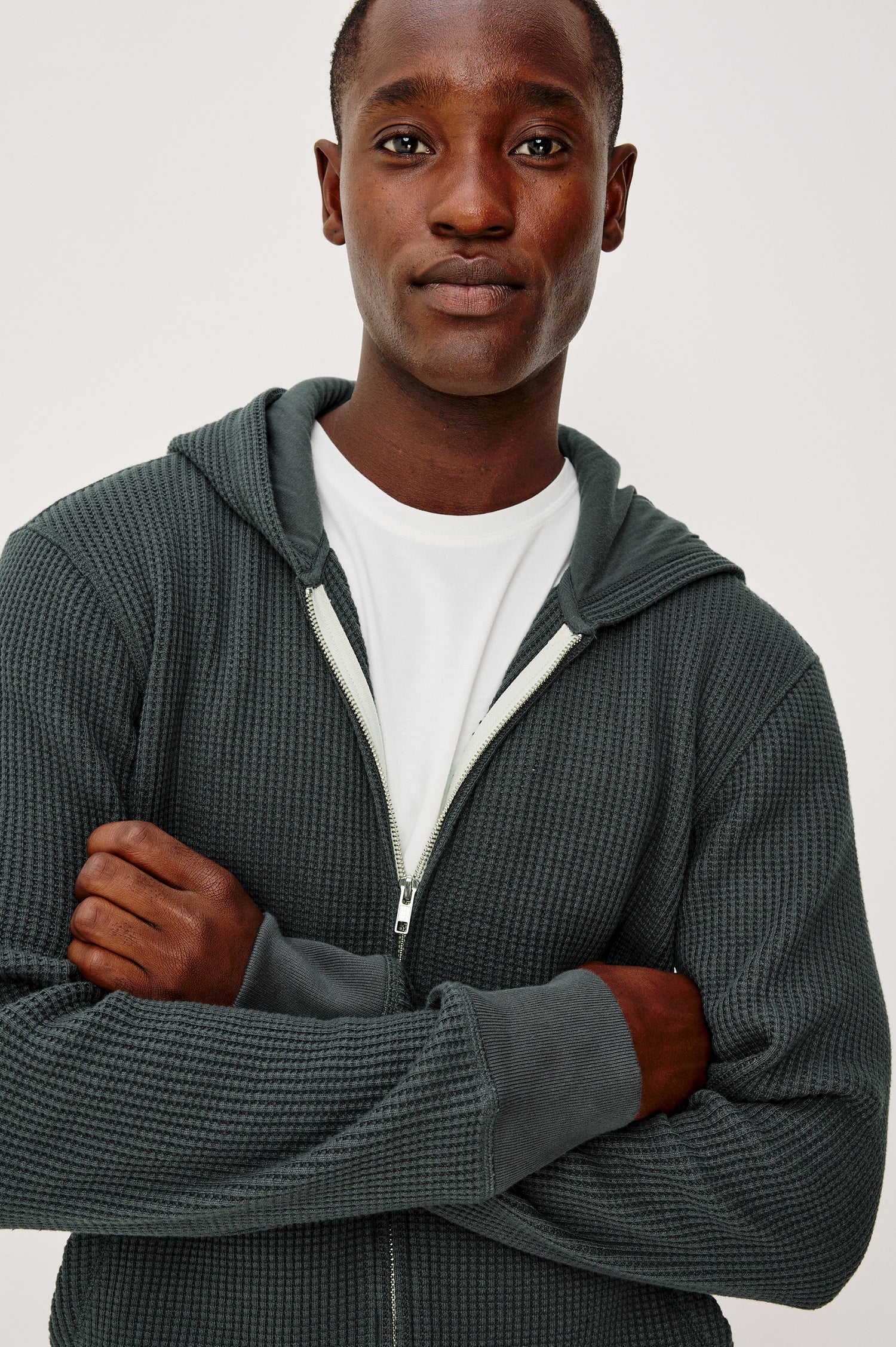 Kenton Waffle Knit Zip Front Hoodie Sweatshirt With Front Patch Pockets, Long Sleeves, and Ribbed Cuffs in Ink Colorway - Upper Body Front Close Up View Featured on Model