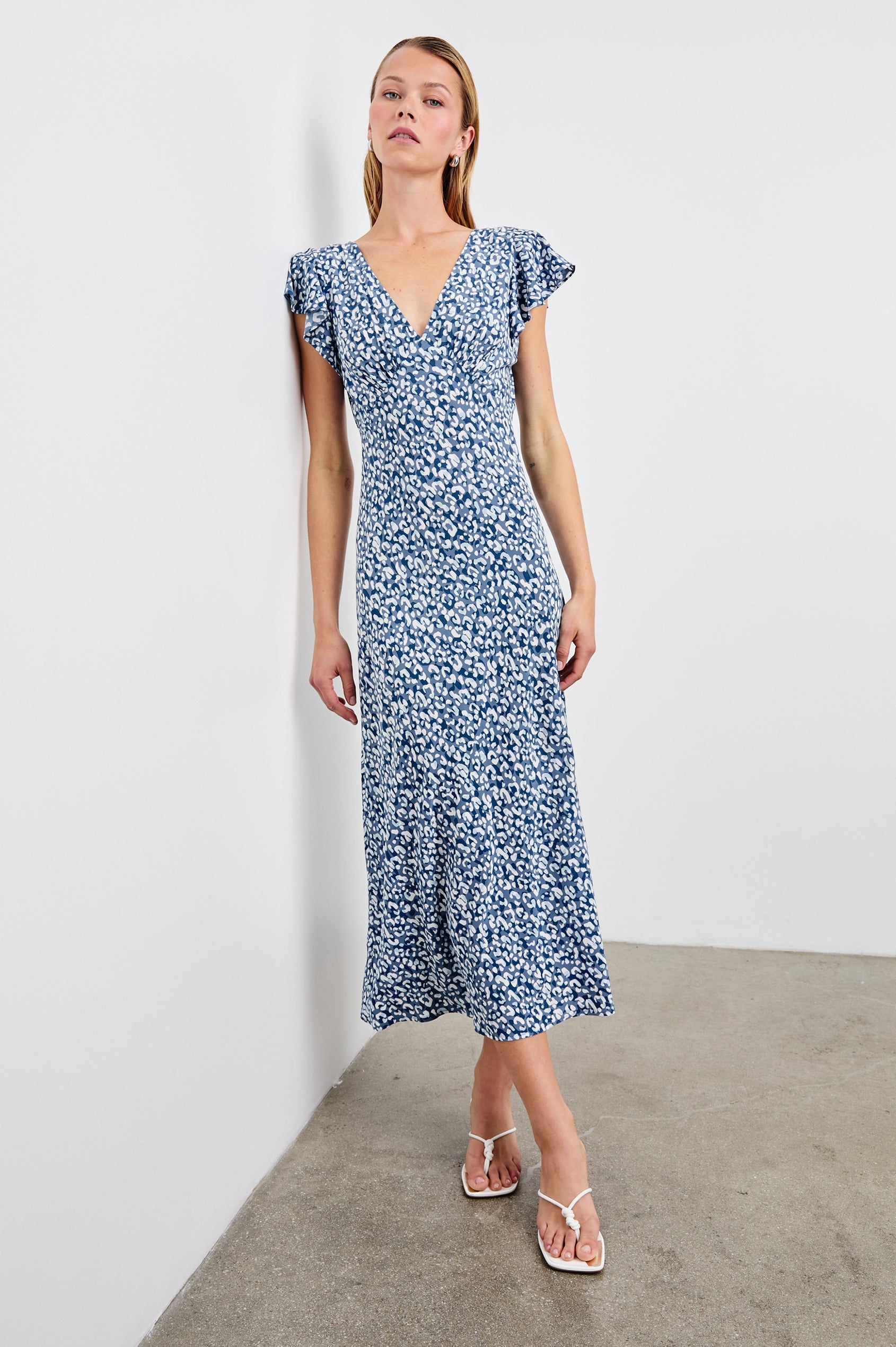 Kenz Midi Dress with Flutter cap Sleeves, and a deep V Neck in Blue Mixed Cheetah Colorway, Spots in Blues and White - Front Full Body View Featured on Model
