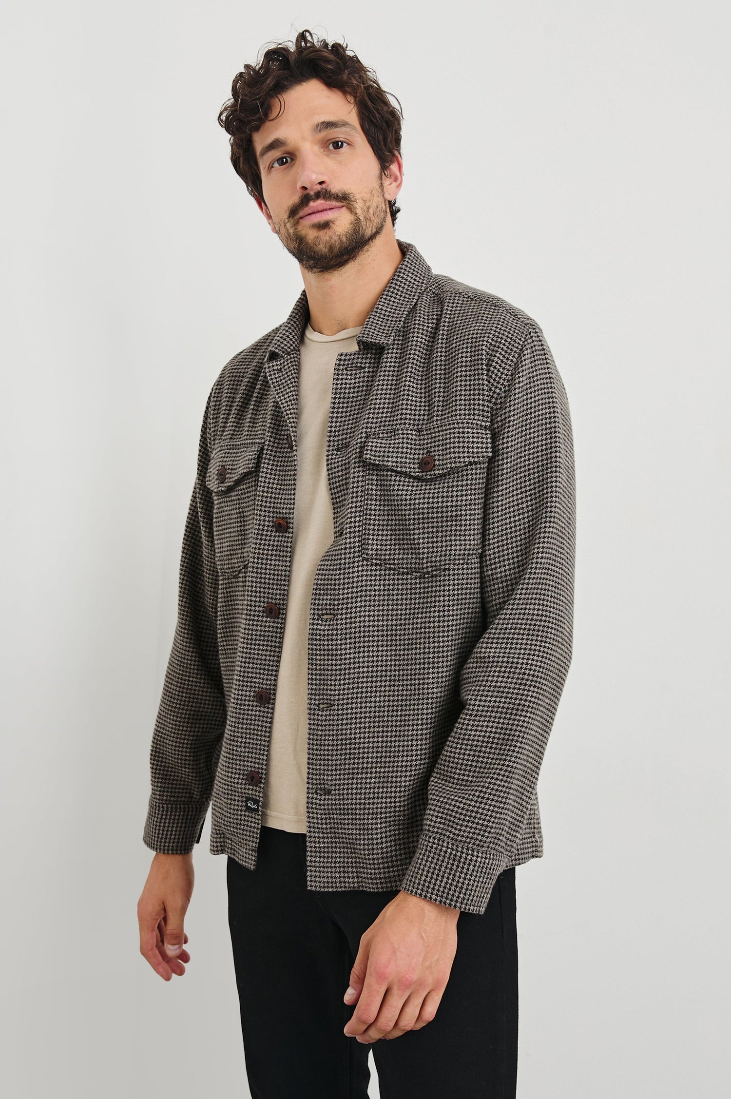 Kerouac Long-Sleeve Shirt Jacket with Button Closure and Two Button Chest Flap Pockets in Mire Colorway, a Tan and Black Houndstooth - Front Unbuttoned View Featured on Model
