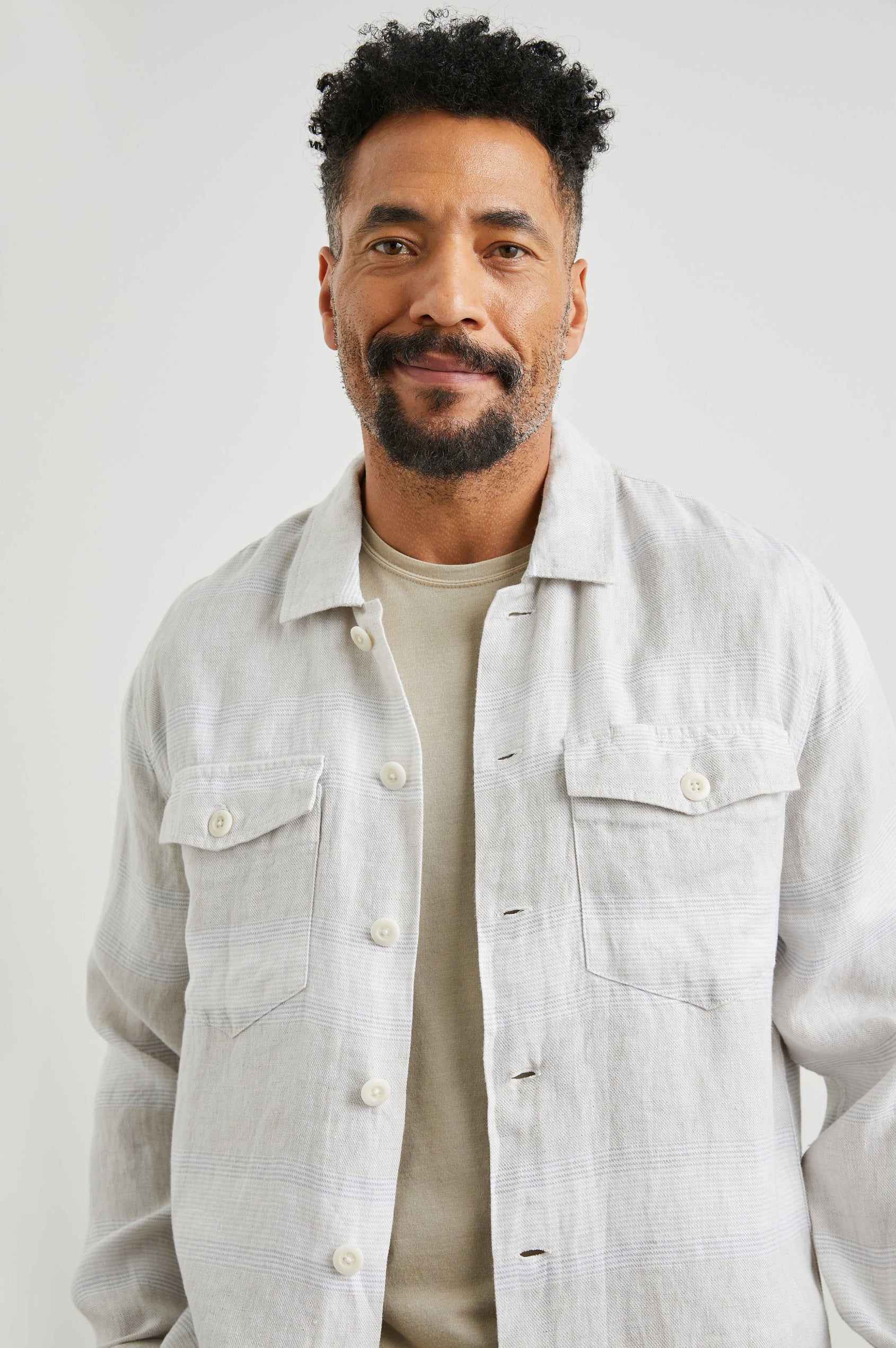 Kerouac Long-Sleeve Shirt Jacket with Button Closure and Two Button Chest Flap Pockets in Wicker Graphite Stripe Colorway, Grey and White Horizontal Stripes on Wicker  - Front Unbuttoned View Featured on Model