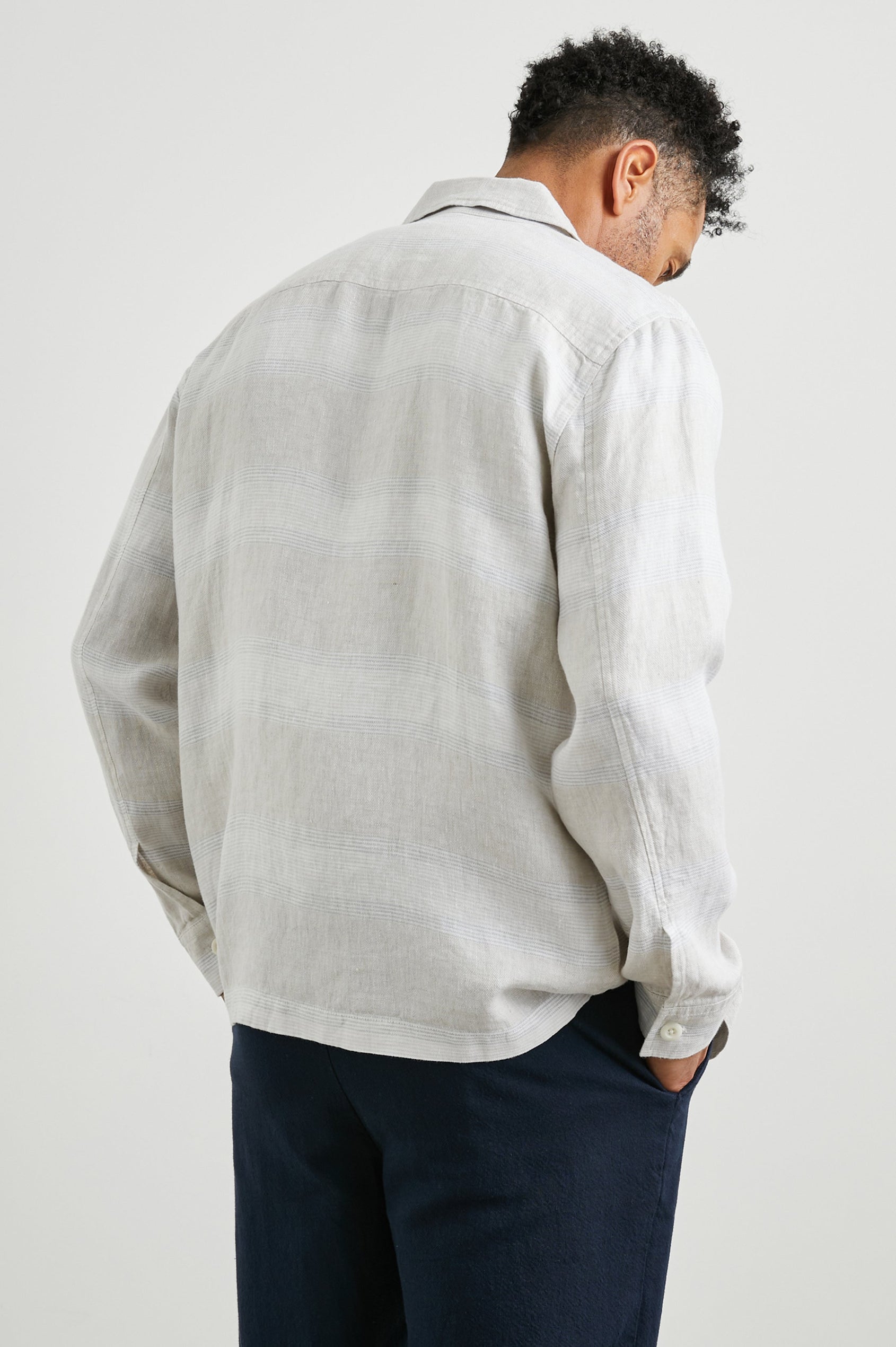 Kerouac Long-Sleeve Shirt Jacket with Button Closure and Two Button Chest Flap Pockets in Wicker Graphite Stripe Colorway, Grey and White Horizontal Stripes on Wicker  - Back Unbuttoned View Featured on Model