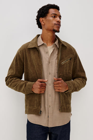 Ketter Zip Up Jacket with Two Curved Front Patch Pockets, a Diagonally Zippered Chest Patch Pocket and Adjustable Button Straps on the Hem in Chicory Colorway, a Warm Brown with Non Contrast Collar - Front View Featured on Model.