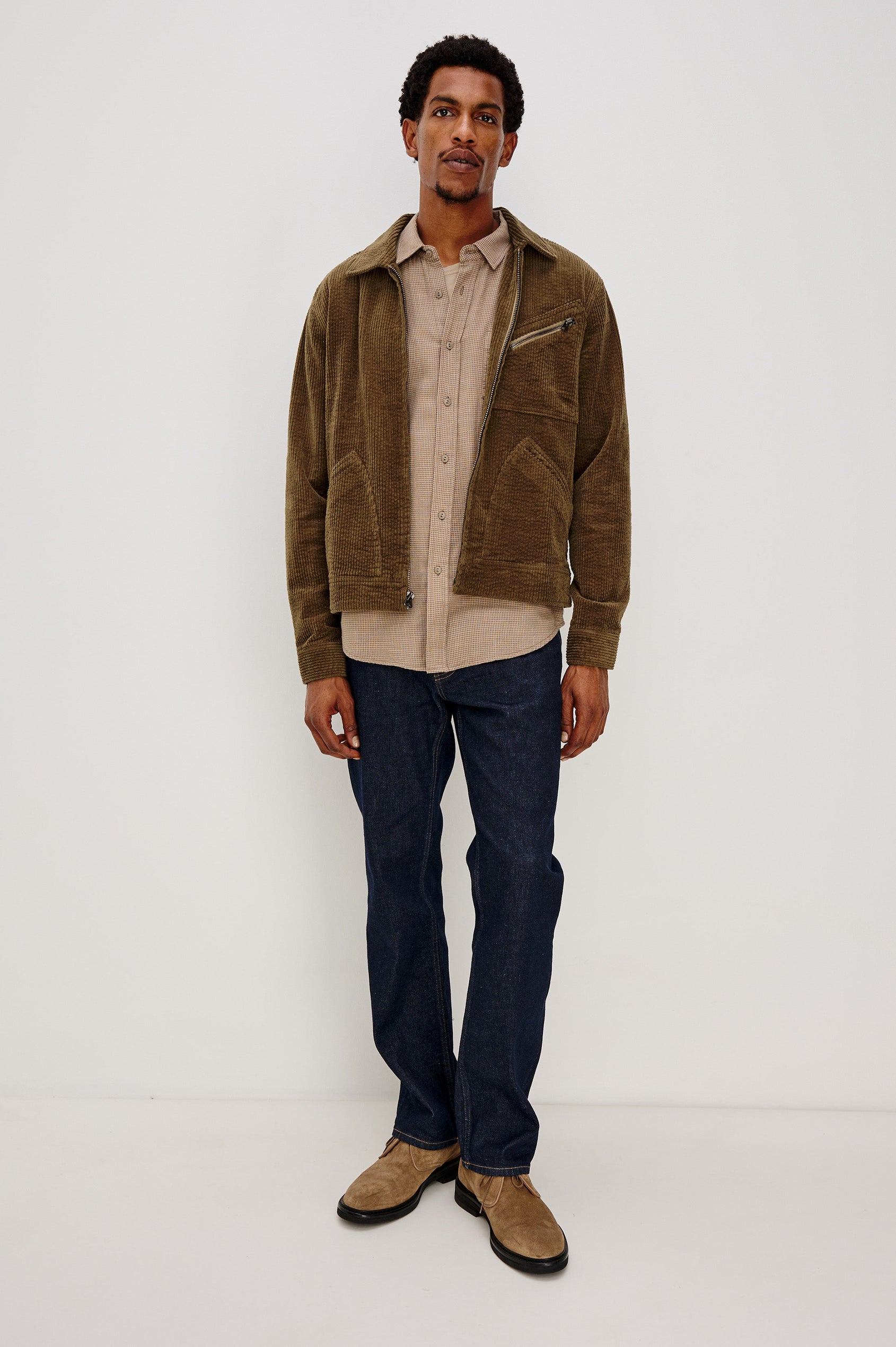 Ketter Zip Up Jacket with Two Curved Front Patch Pockets, a Diagonally Zippered Chest Patch Pocket and Adjustable Button Straps on the Hem in Chicory Colorway, a Warm Brown with Non Contrast Collar - Front Full Body View Featured on Model.