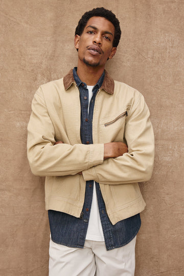 Ketter Zip Up Jacket with Two Curved Front Patch Pockets, a Diagonally Zippered Chest Patch Pocket and Adjustable Button Straps on the Hem in Duck Colorway, a Tan with a Darker Brown Collar - Front View Featured on Model