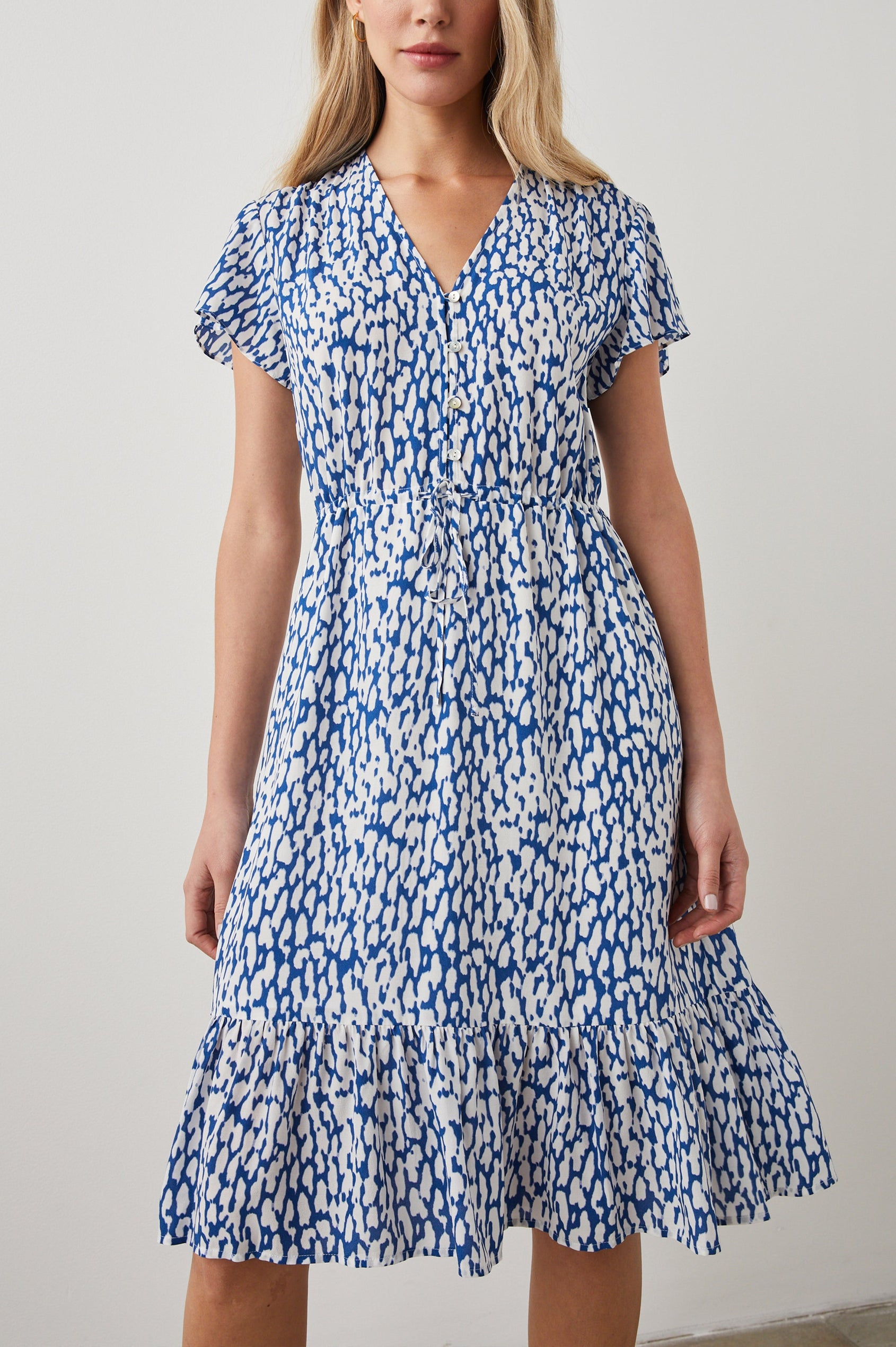 Kiki Short Sleeve Midi Dress with a V Neck, Buttons Down the Front Bodice, a Drawstring Waist and Ruffles at the Hem in Cobalt Static Leopard Colorway, a Blue and White Print - Front View Featured on Model 