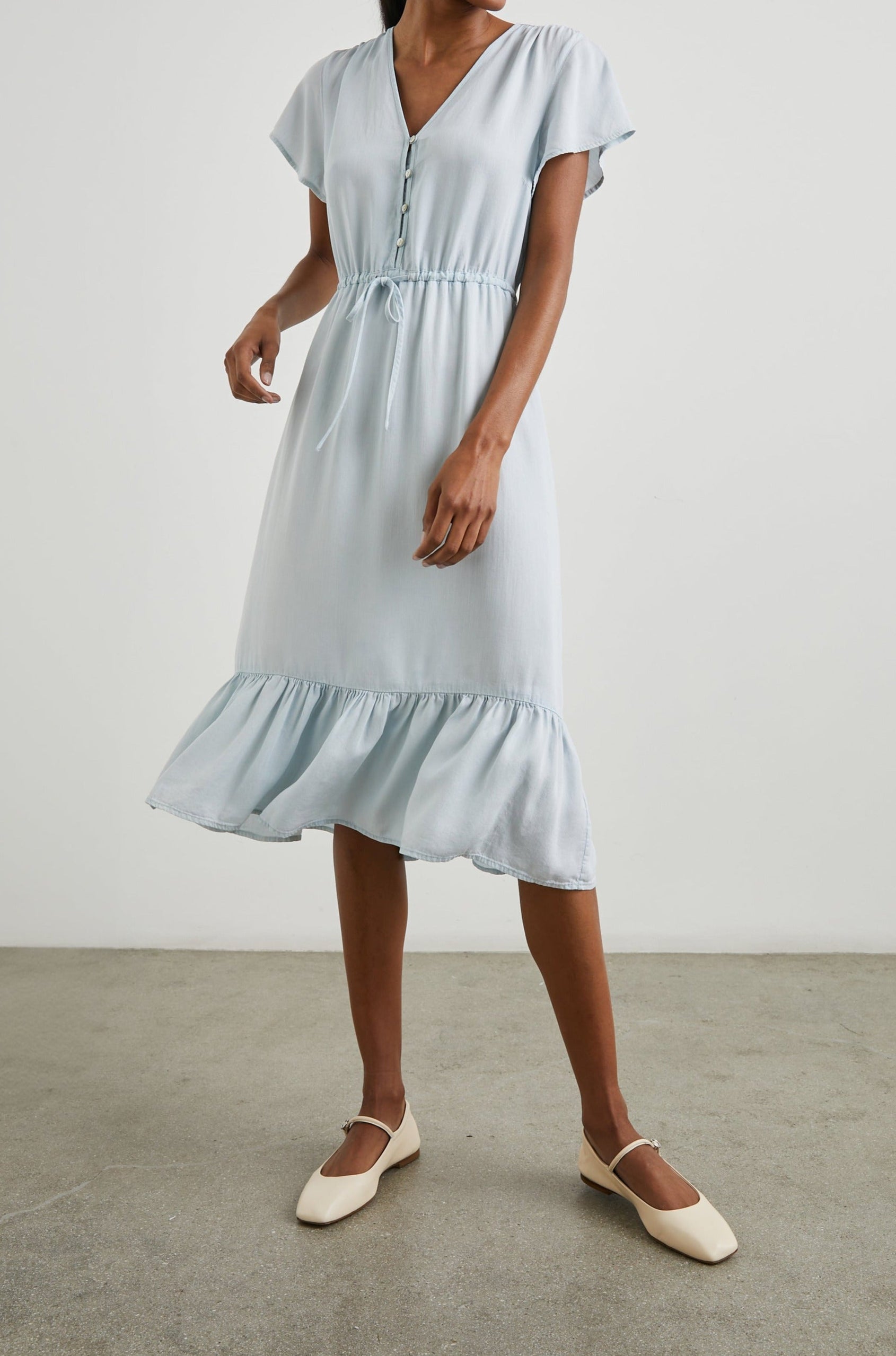 Kiki Short Sleeve Midi Dress with a V Neck, Buttons Down the Front Bodice, a Drawstring Waist and Ruffles at the Hem in Light Vintage Colorway - Front Full Body View Featured on Model 