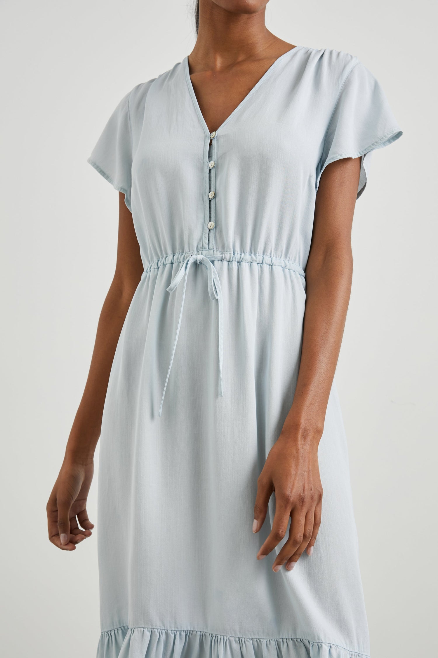 Kiki Short Sleeve Midi Dress with a V Neck, Buttons Down the Front Bodice, a Drawstring Waist and Ruffles at the Hem in Light Vintage Colorway - Front View Featured on Model 
