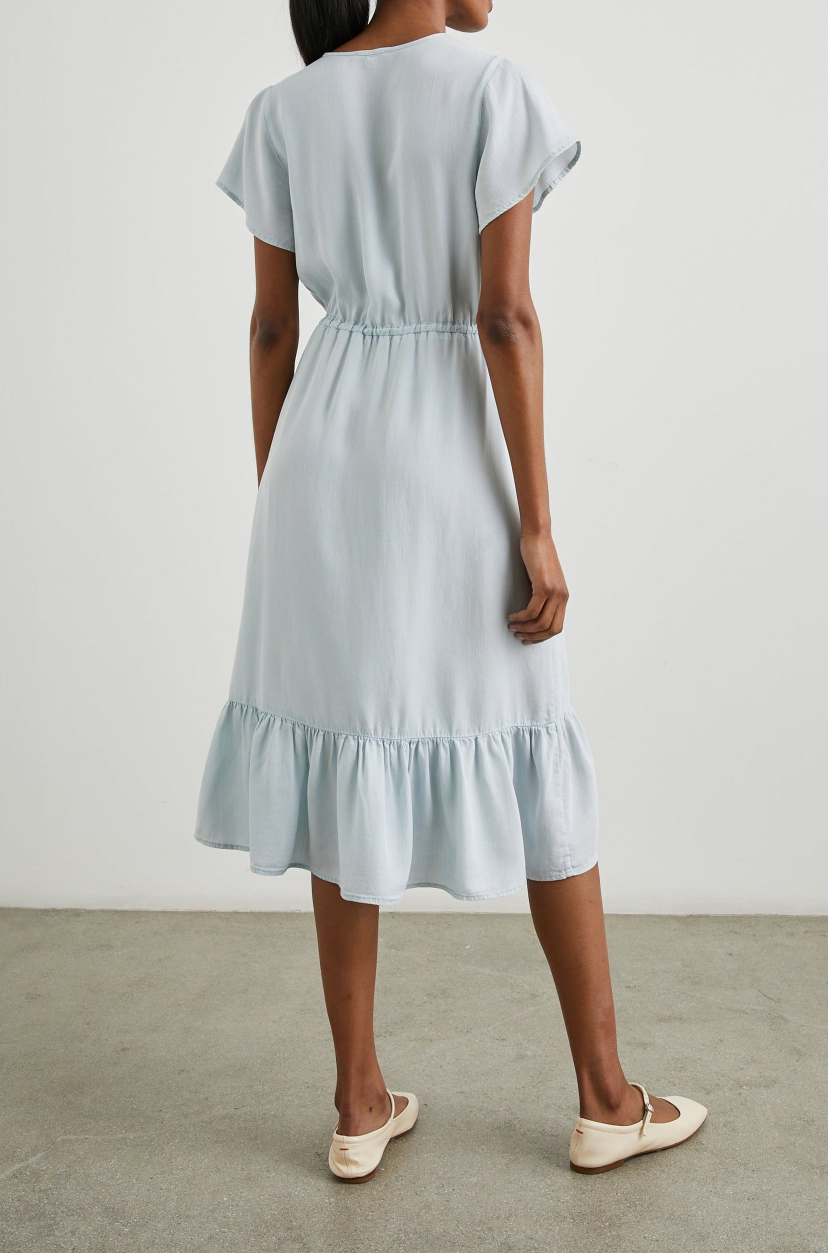 Kiki Short Sleeve Midi Dress with a V Neck, Buttons Down the Front Bodice, a Drawstring Waist and Ruffles at the Hem in Light Vintage Colorway - Back Full Body View Featured on Model 