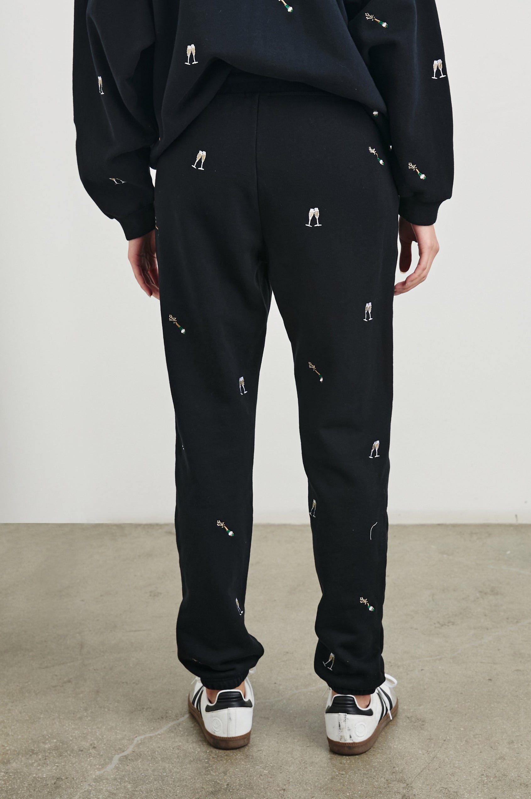 Kingston Pants with Elastic Cuffs and Waist with Drawcord in Black Champagne Embroidery Colorway, Champagne Glasses on Black - Back View Featured on Model