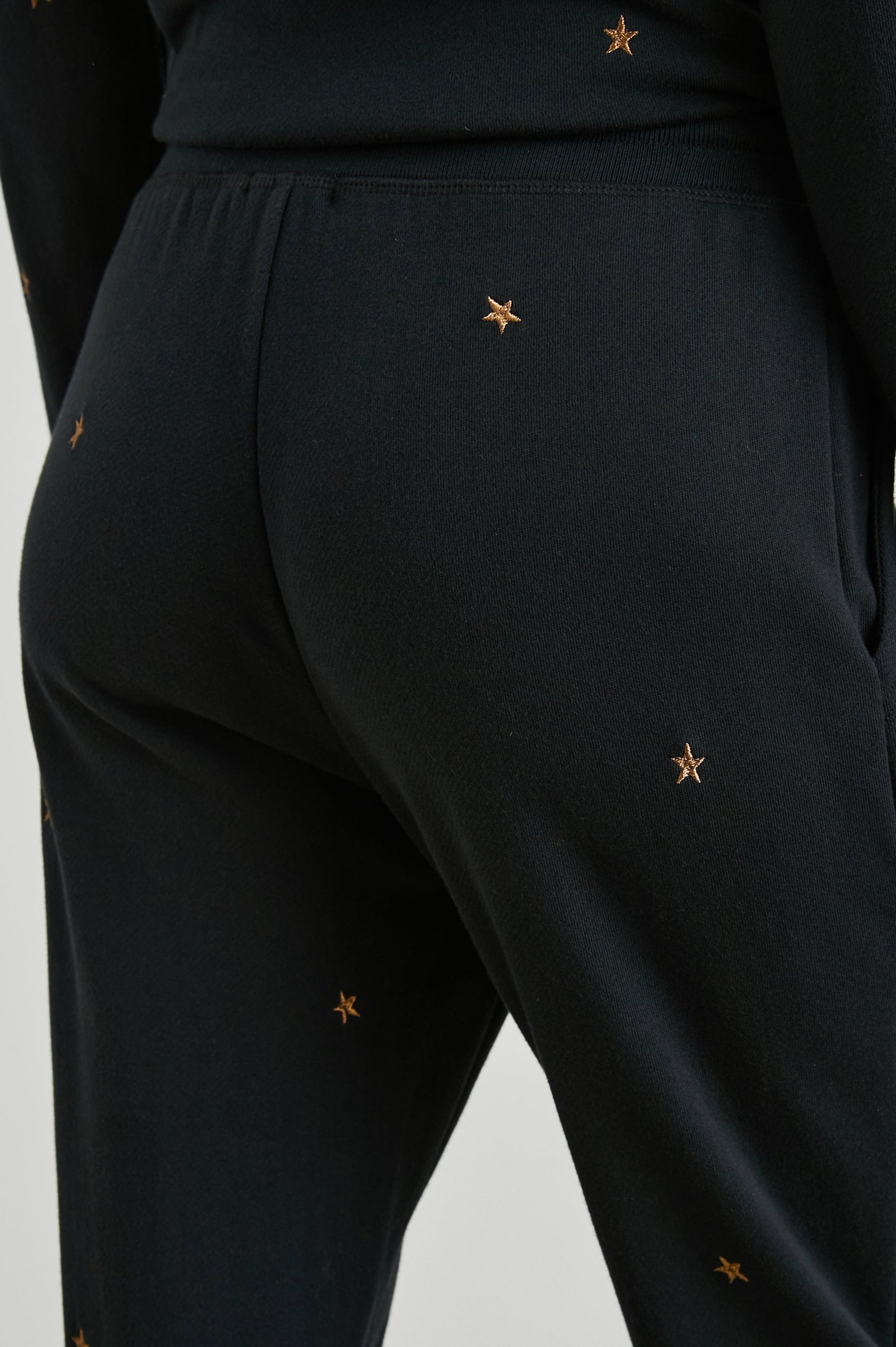 Kingston Sweatpants with Elastic Cuffs and Waist with Drawcord in Bronze Star Embroidery Colorway, Bronze Stars on Black - Front View Featured on Model