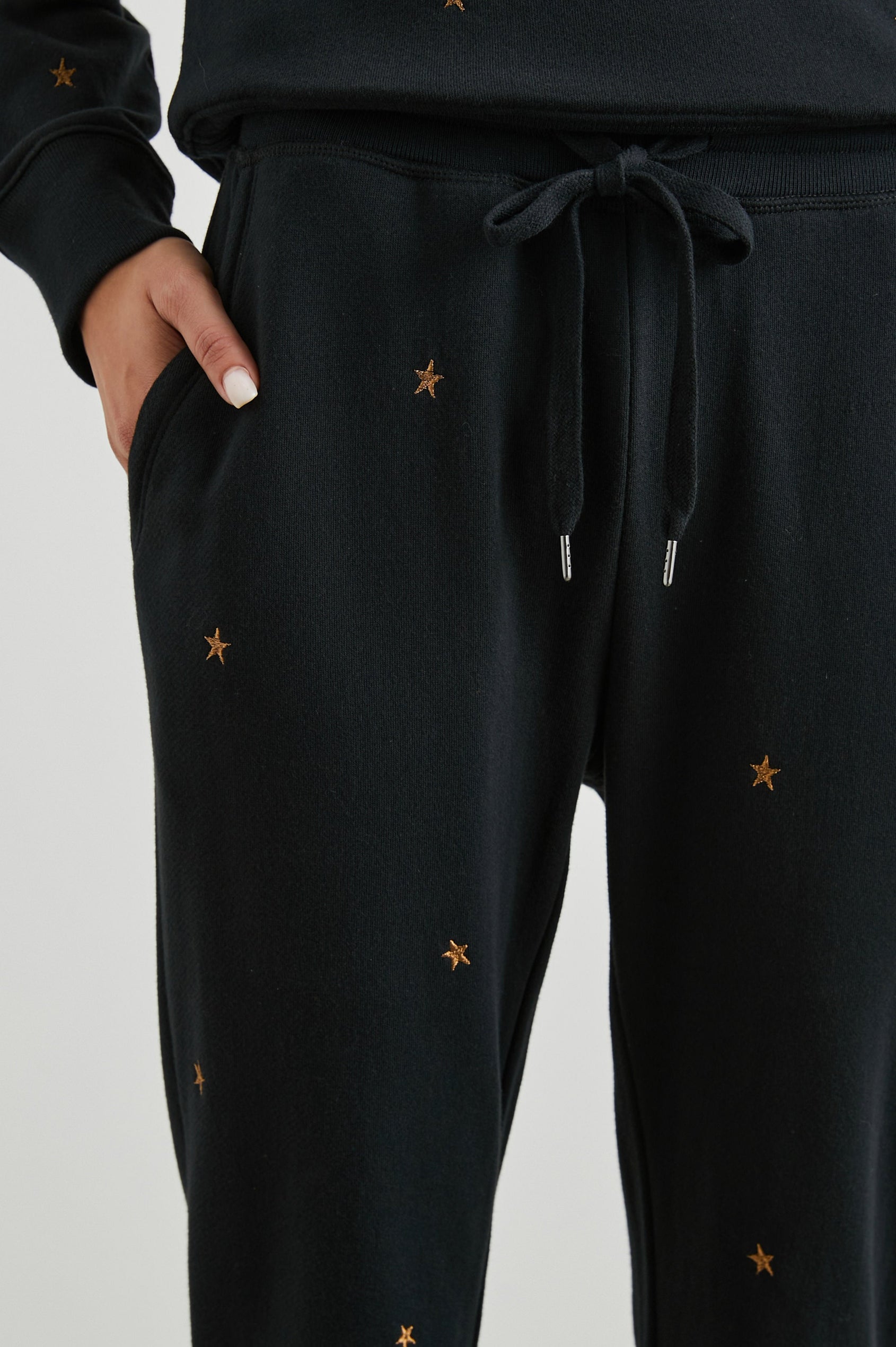 Kingston Sweatpants with Elastic Cuffs and Waist with Drawcord in Bronze Star Embroidery Colorway, Bronze Stars on Black - Front View Featured on Model