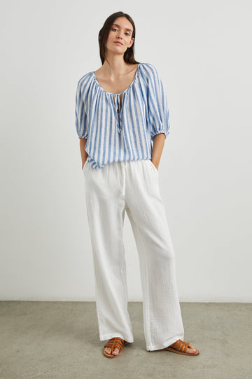Kristie Top with Elbow Length Sleeves with Elasticized Cuffs and a Deep V Neck with a Tie in Casablanca Stripe Colorway, Blue and White Vertical Stripes - Front Full Body View Featured on Model  