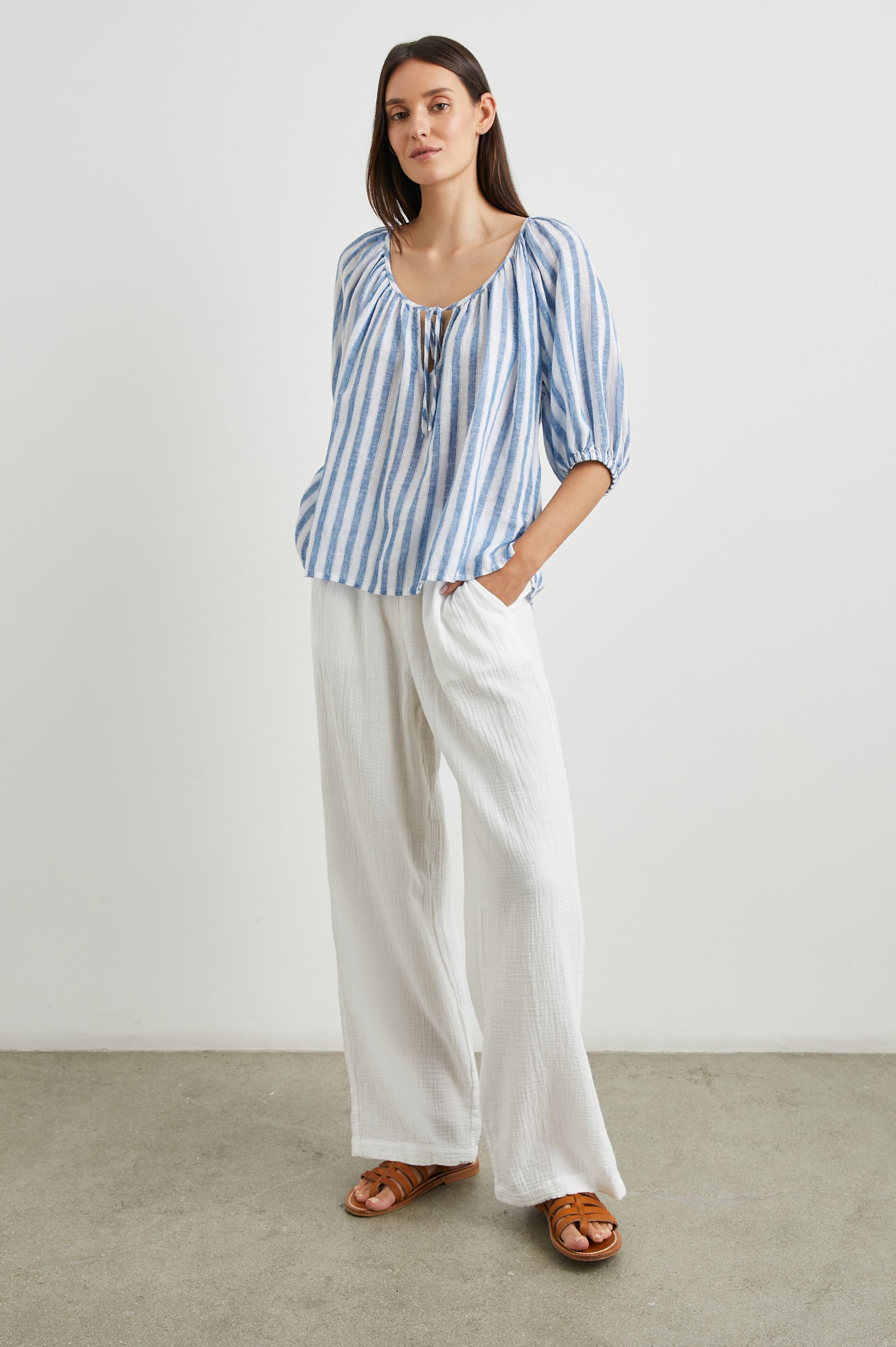 Kristie Top with Elbow Length Sleeves with Elasticized Cuffs and a Deep V Neck with a Tie in Casablanca Stripe Colorway, Blue and White Vertical Stripes - Front Full Body View Featured on Model  