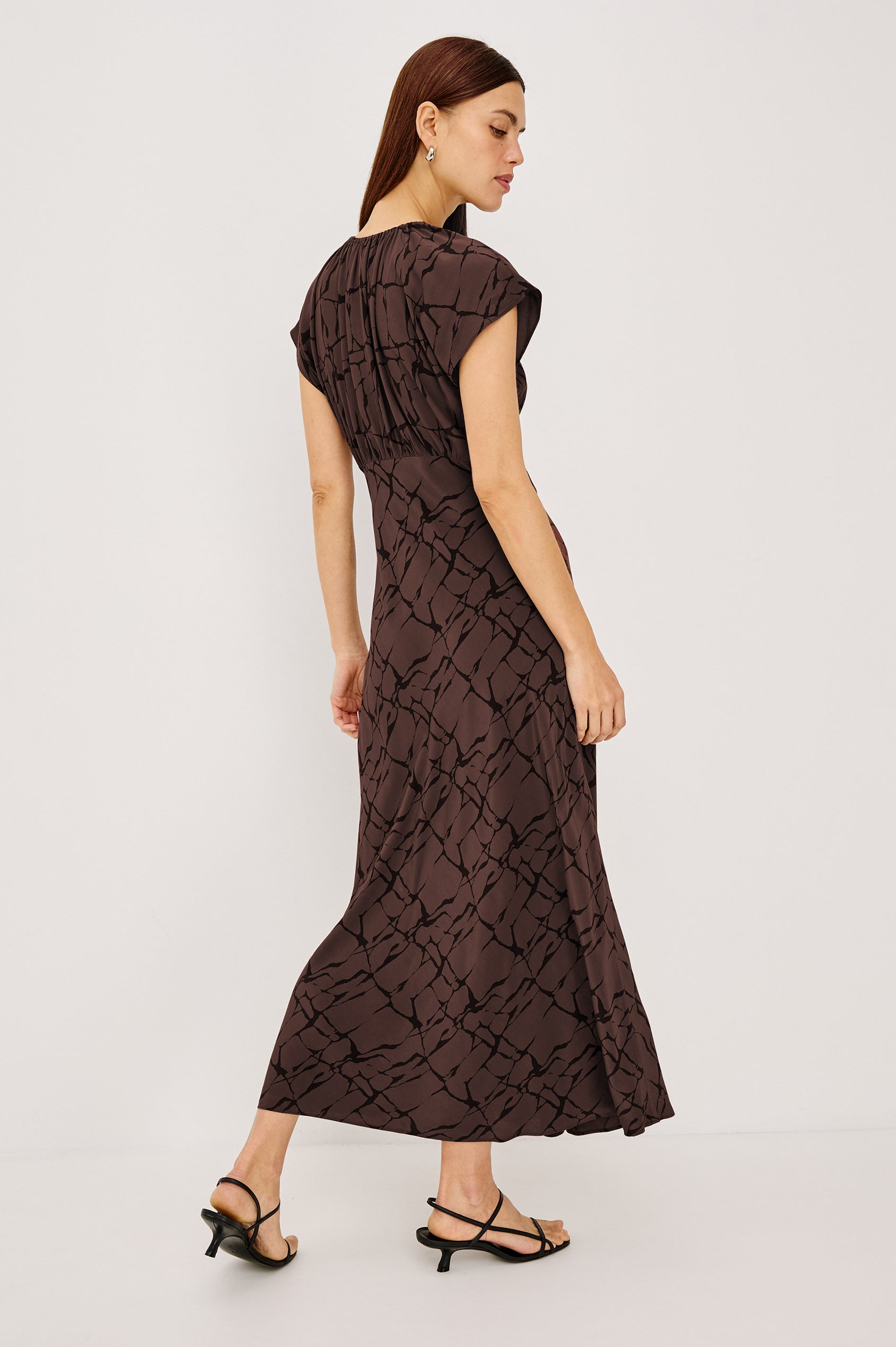 Kourt Midi Dress in Lightweight Crepe With Elastic V-Neckline, Empire Waist, Extended Cap Sleeves, and Hidden Side Zip in Brown Obsidian Colorway - Full Body Back View Featured on Model