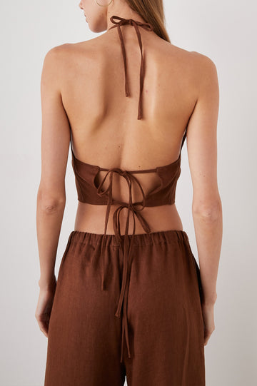Kyra Sleeveless Crop Top with a Halter Neckline with a Back Neck Tie, an Open Back with Two Tie Closure and a Vertical Seam at the Front Center in Cacao Colorway - Back View Featured on Model  