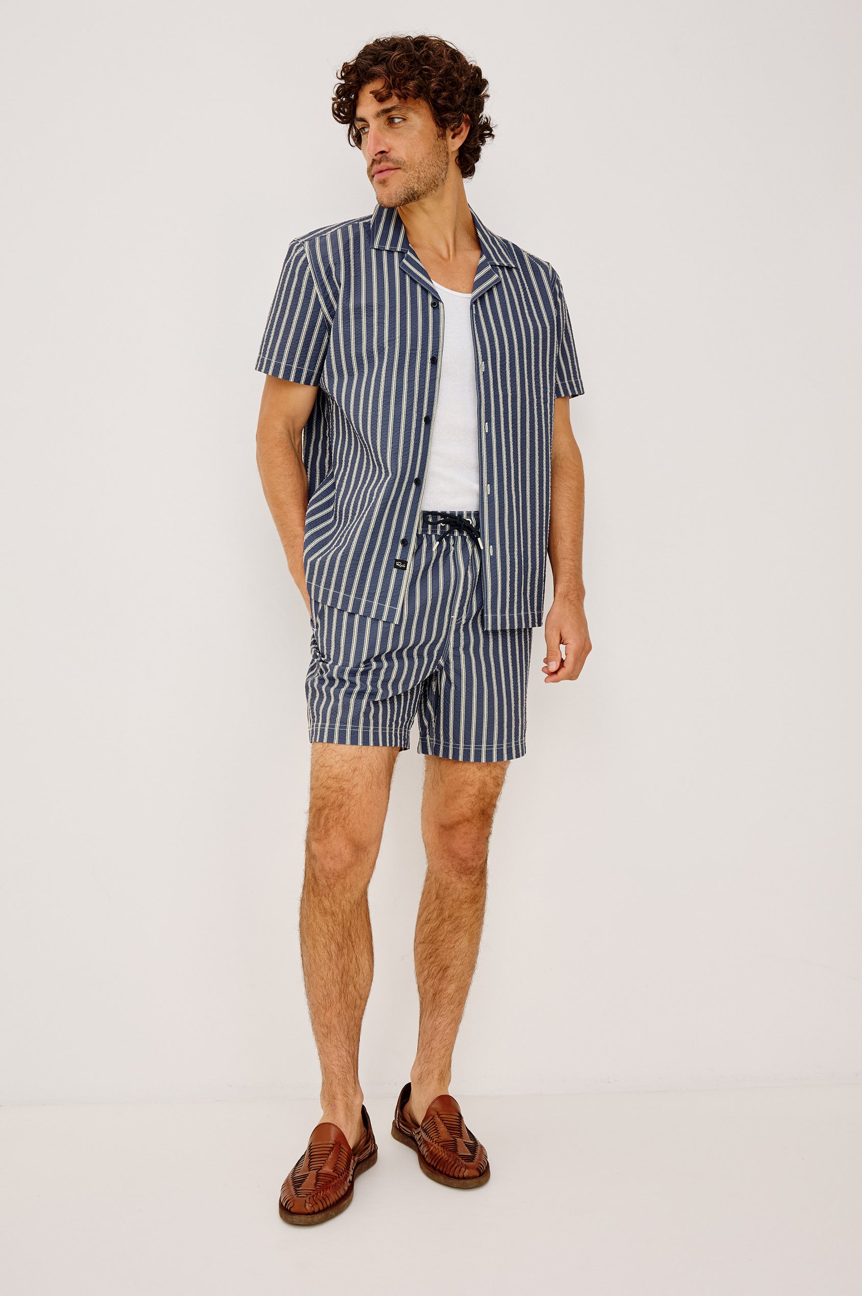 La Brea Swim Short With Adjustable Waist Drawstring Ties, Mid-Length Fit, and Side Pockets in Navy Cream Stripe Colorway - Full Body Front View Featured on Model