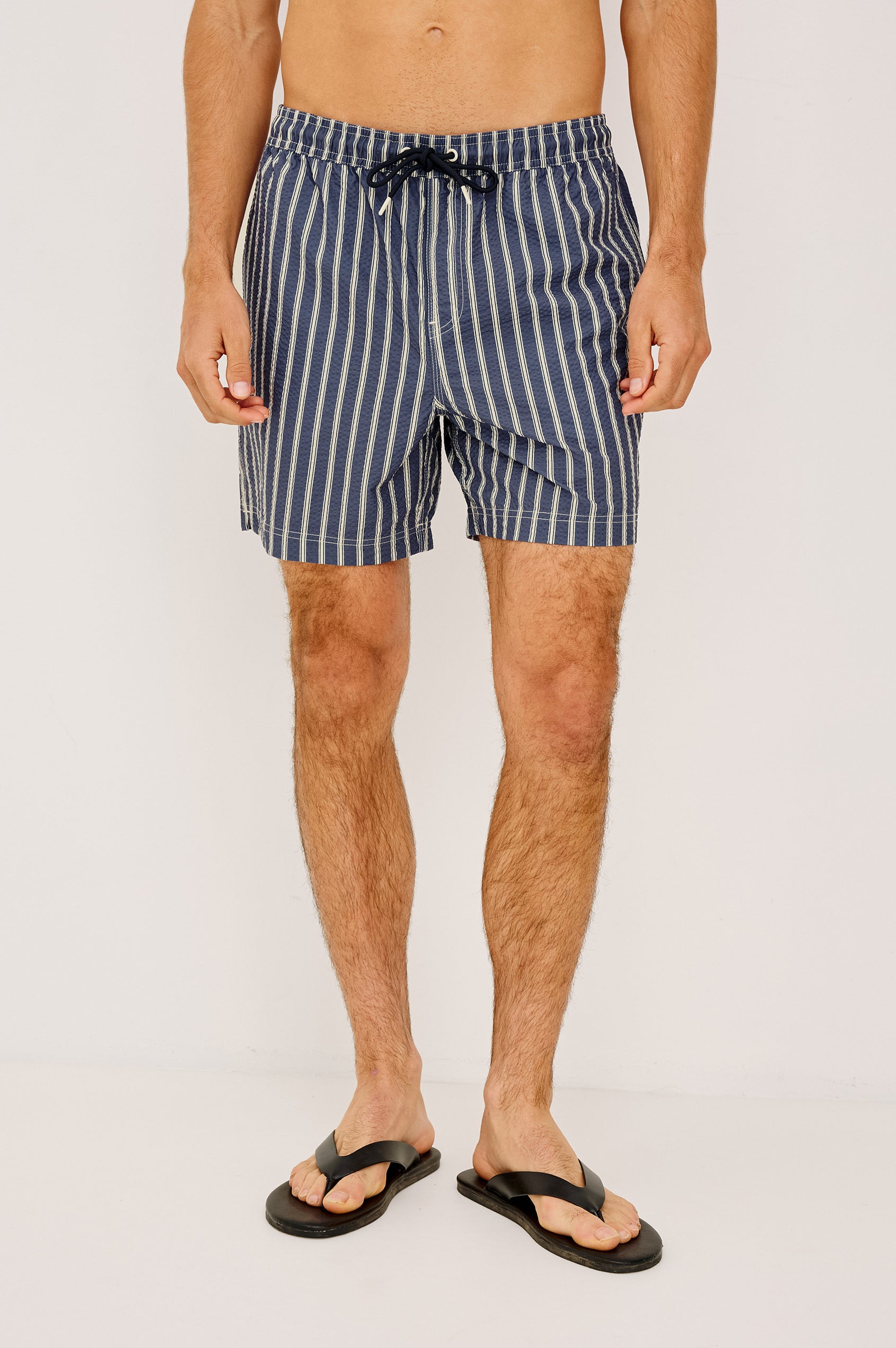 La Brea Swim Short With Adjustable Waist Drawstring Ties, Mid-Length Fit, and Side Pockets in Navy Cream Stripe Colorway - Full Body Front View Featured on Model
