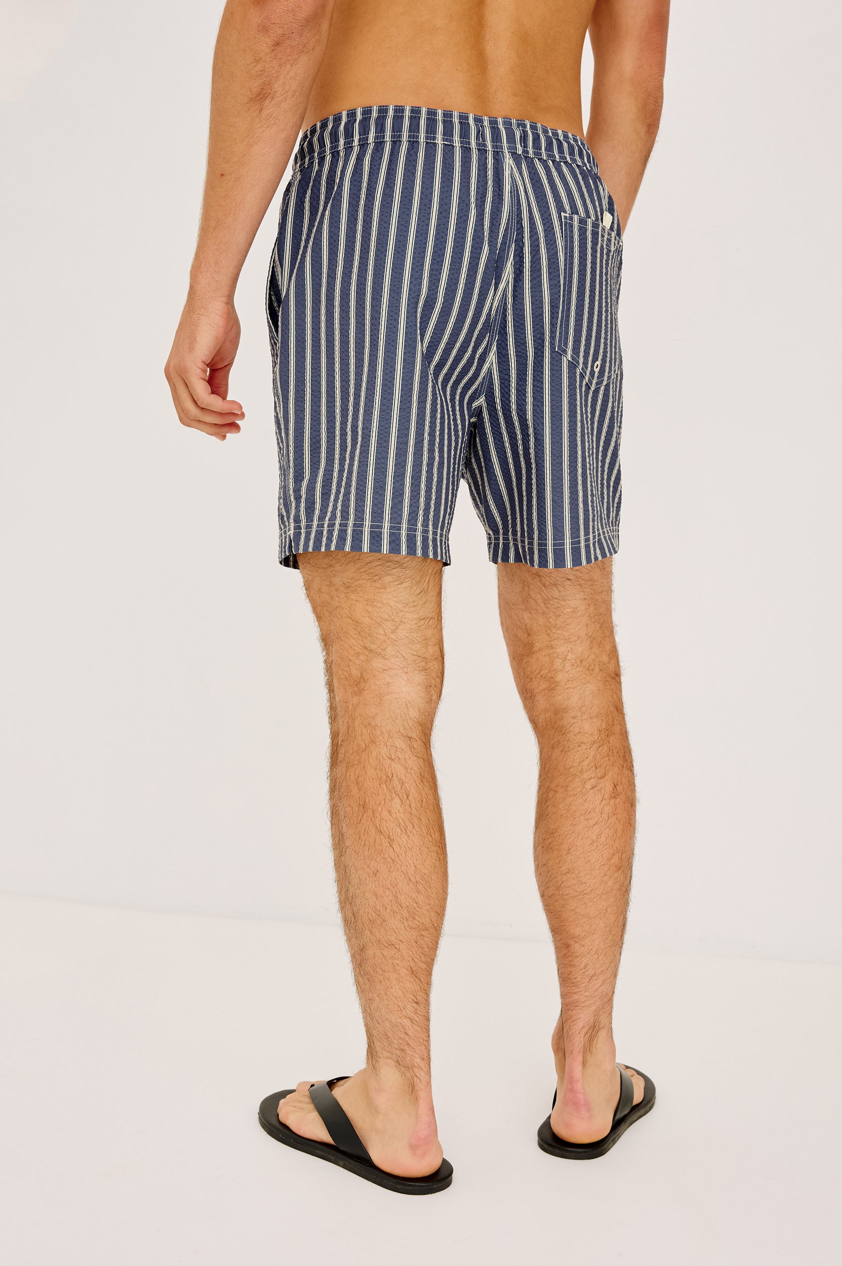 La Brea Swim Short With Adjustable Waist Drawstring Ties, Mid-Length Fit, and Side Pockets in Navy Cream Stripe Colorway - Lower Body Back View Featured on Model