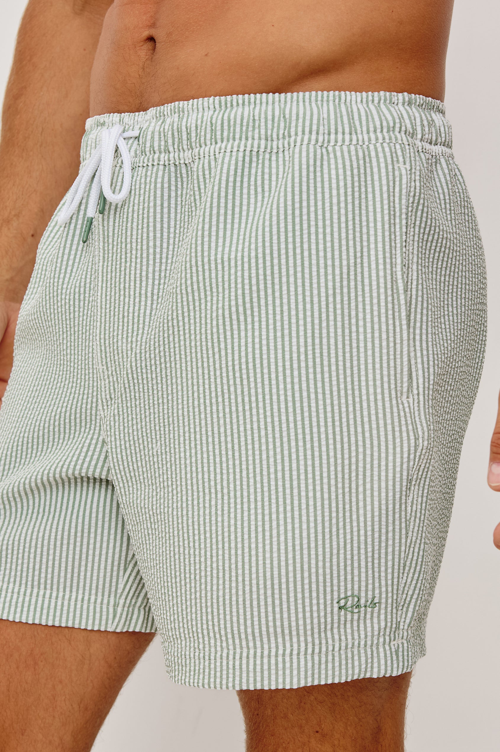 The Amalfi Button-Up Short Sleeve Shirt in Lightweight Stretch Linen-Blend With a Notched Collar and Classic Fit in Sage White Seersucker - Lower Body Front View Featured on Model