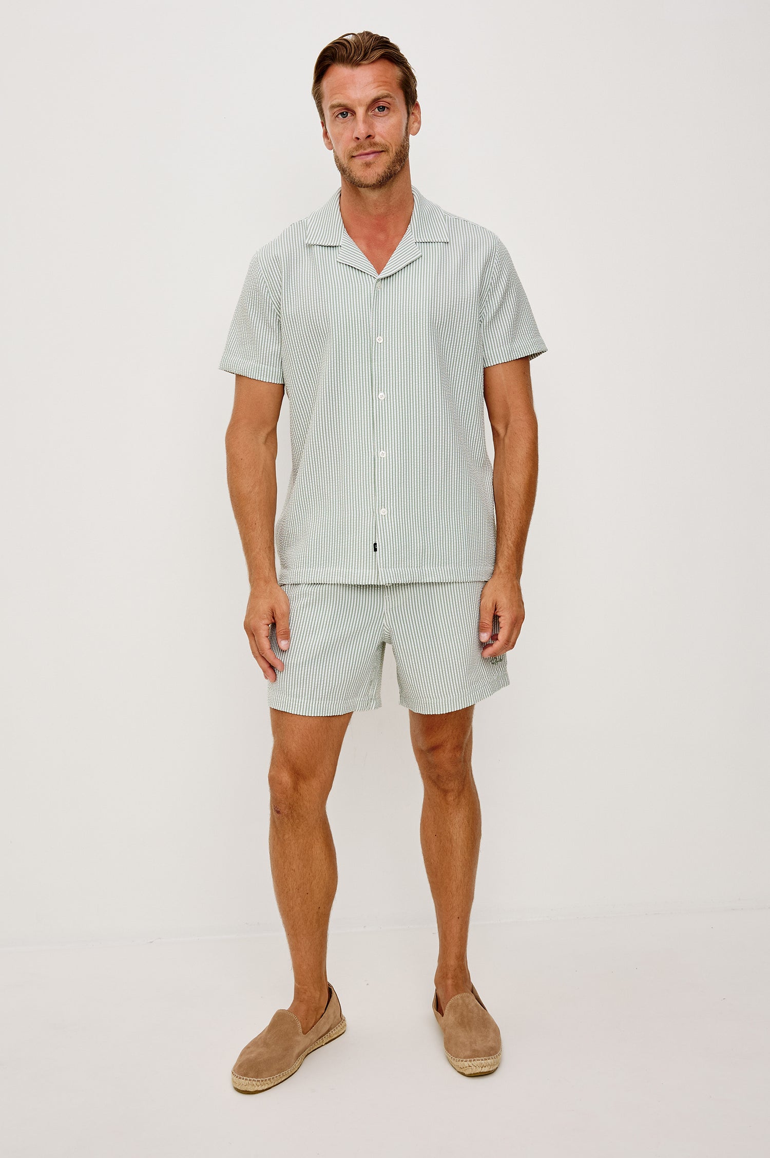 The Amalfi Button-Up Short Sleeve Shirt in Lightweight Stretch Linen-Blend With a Notched Collar and Classic Fit in Sage White Seersucker - Full Body Front View Featured on Model
