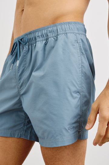 La Brea textured mid-length swim short with adjustable waist drawstring in Slate Blue - close up of details on model