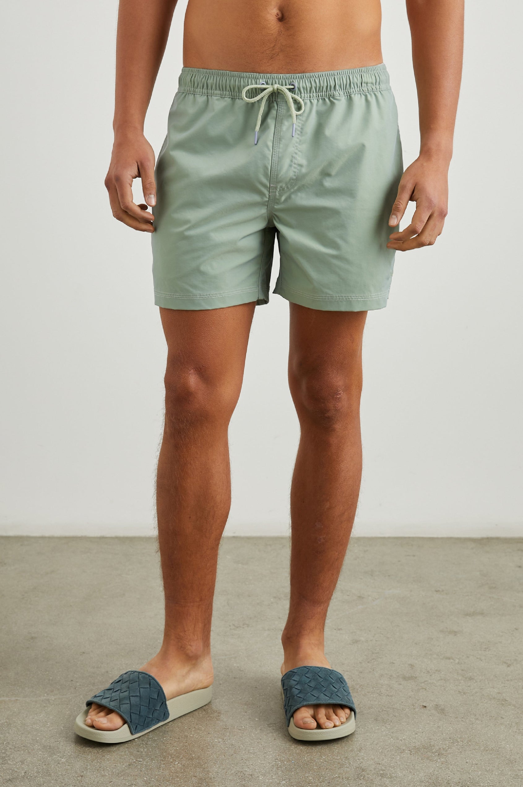 La Brea Swim Shorts with a Drawstring Waist, Two Front Pockets and a Back Patch Pocket in Tea Leaf Colorway - Front View Featured on Model