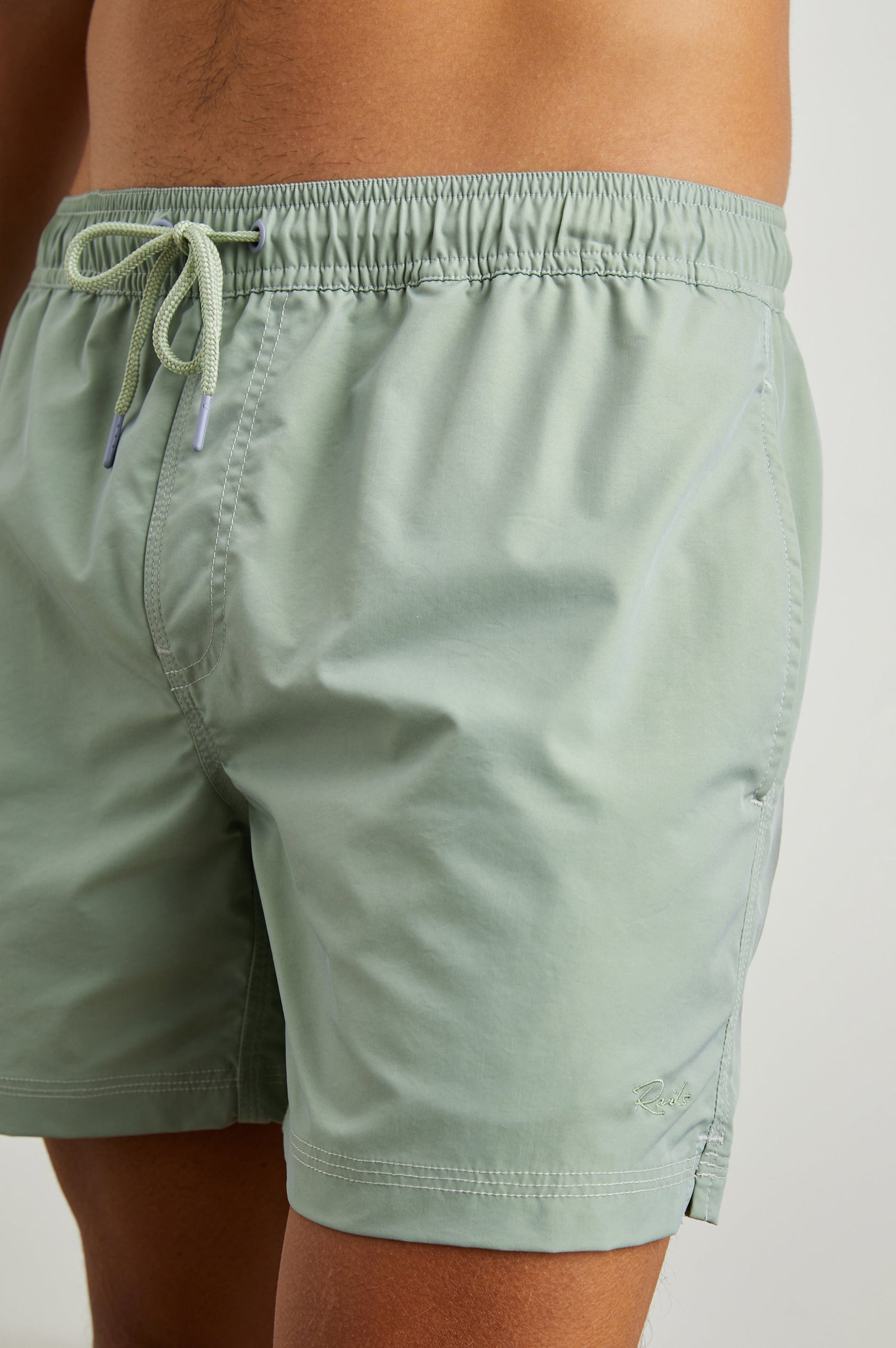 La Brea Swim Shorts with a Drawstring Waist, Two Front Pockets and a Back Patch Pocket in Tea Leaf Colorway - Front View Featured on Model