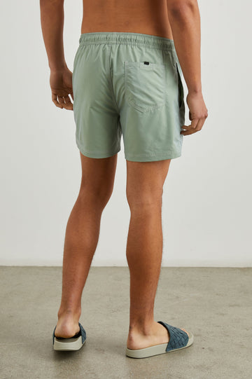La Brea Swim Shorts with a Drawstring Waist, Two Front Pockets and a Back Patch Pocket in Tea Leaf Colorway - Back View Featured on Model