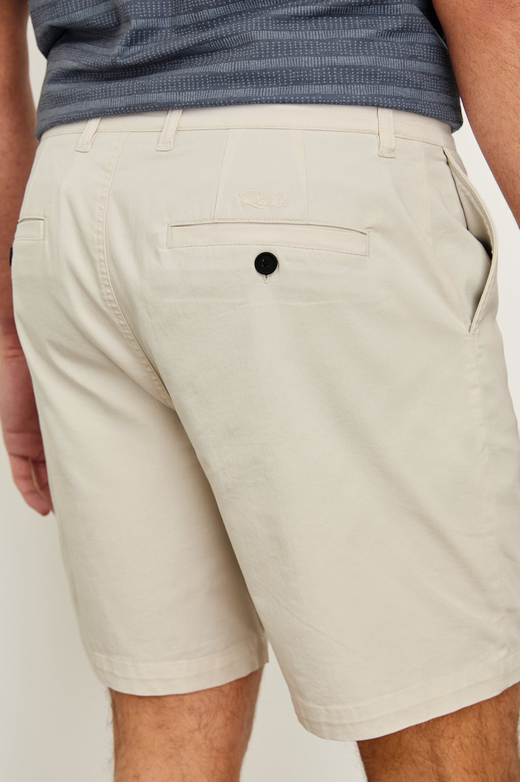 Laguna cotton lid-length short with front button closure and belt loops - close up of back pockets on model