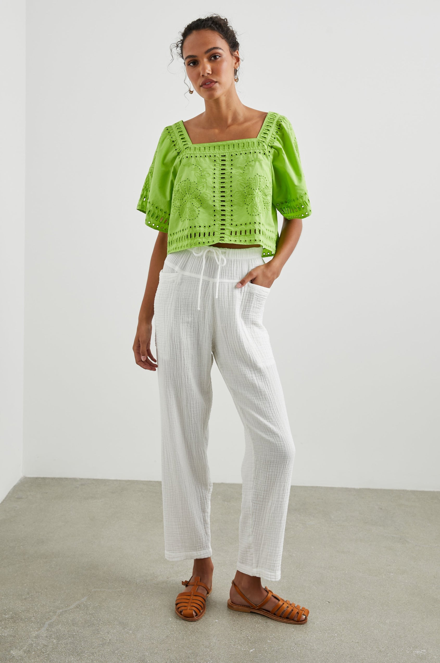 Laine Short Sleeve Crop Top with Square Neckline, and a Floral and Geometric Eyelet Design in Island Green Colorway - Front Full Body View Featured on Model
