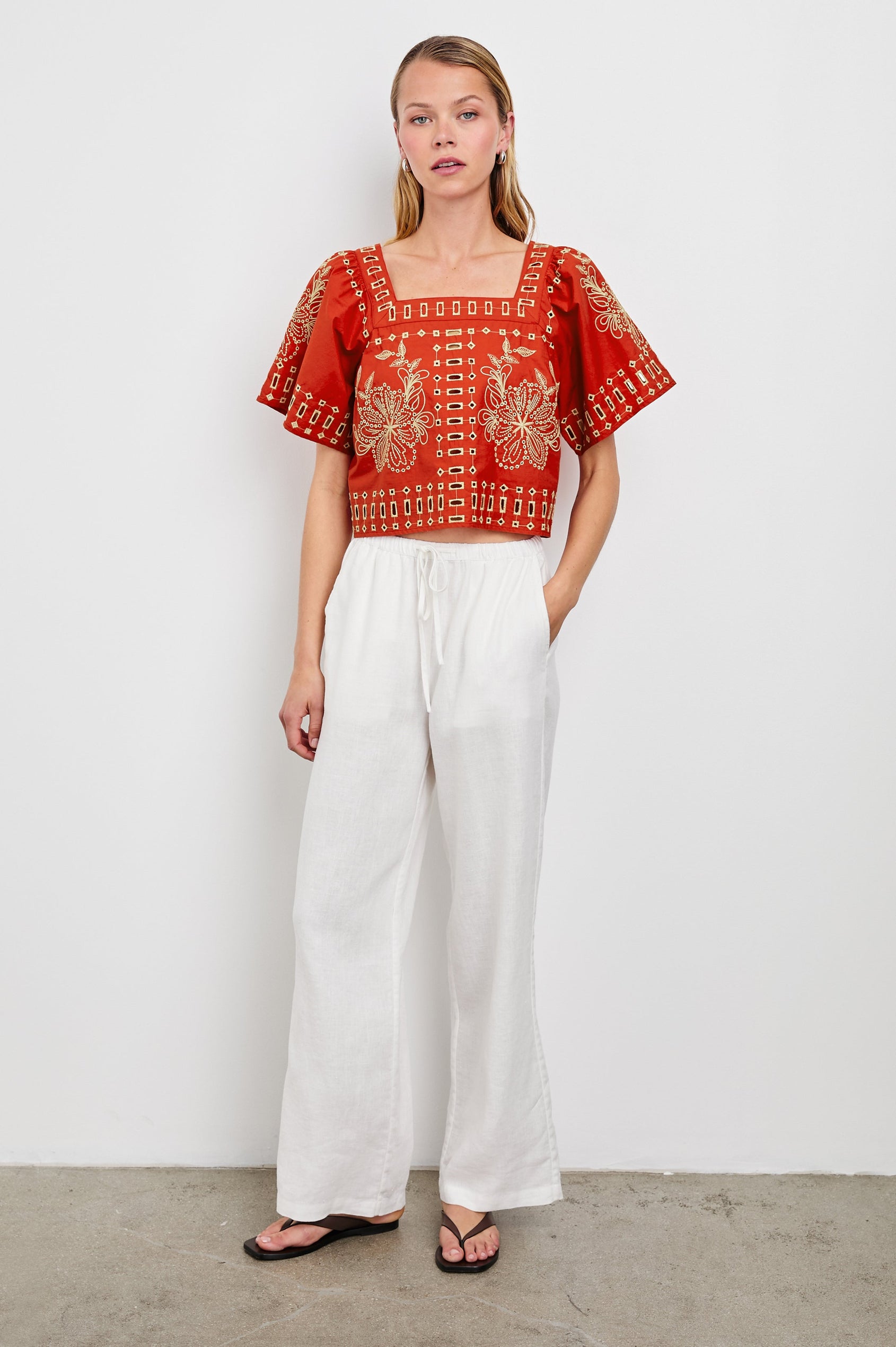 Laine airy cotton poplin top with wide short sleeves and a loose fit. Contrast eyelet embroidery in color Terracotta - full body front view on model