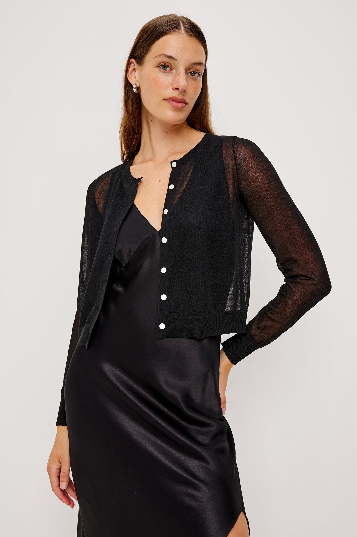 Lakelyn is a sheer button front cardigan with ribbed trim in black colorway. Front view featured on model.