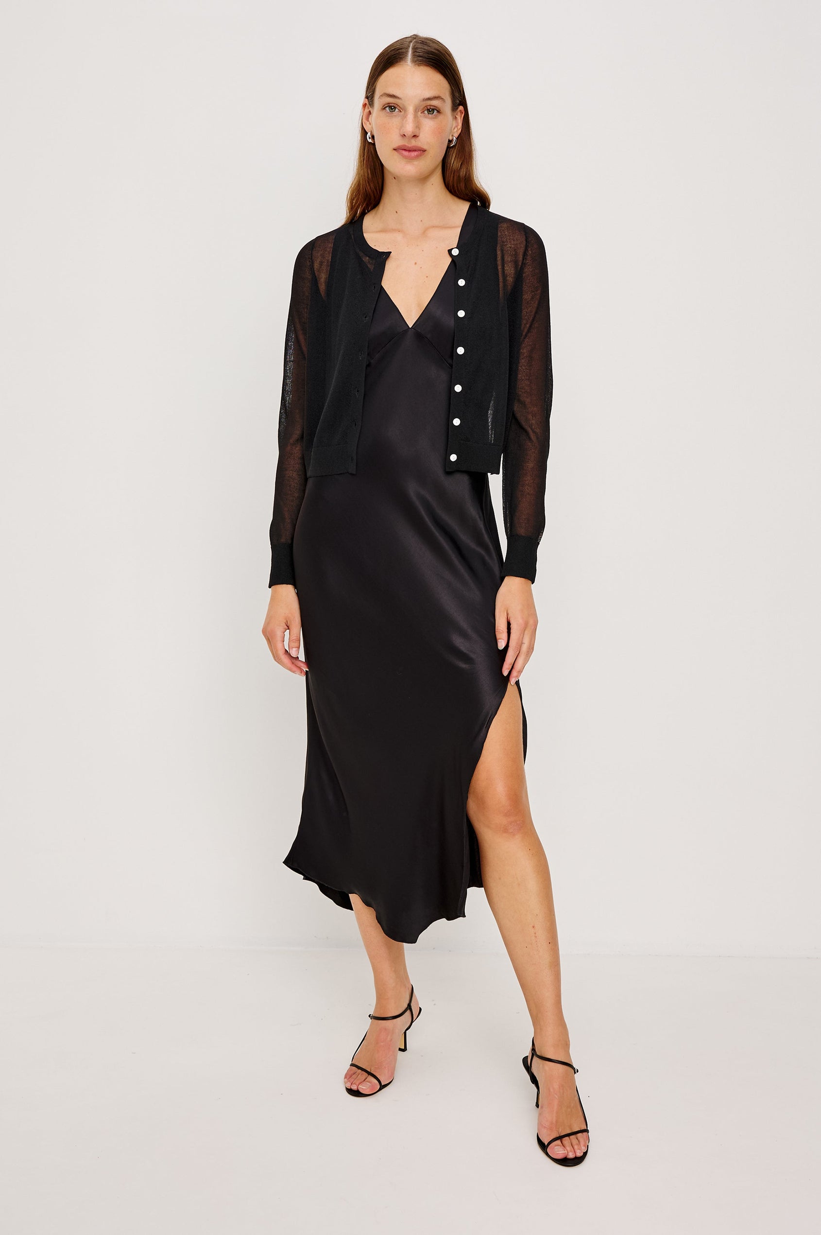 Lakelyn is a sheer button front cardigan with ribbed trim in black colorway. Front full body view featured on model.