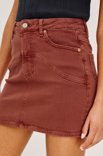 Lockwood Mini Skirt in Denim With Yoke Seam Detailing, Zip Fly, and Pockets in Vintage Brick Colorway - Lower Body Front Close Up View Featured on Model