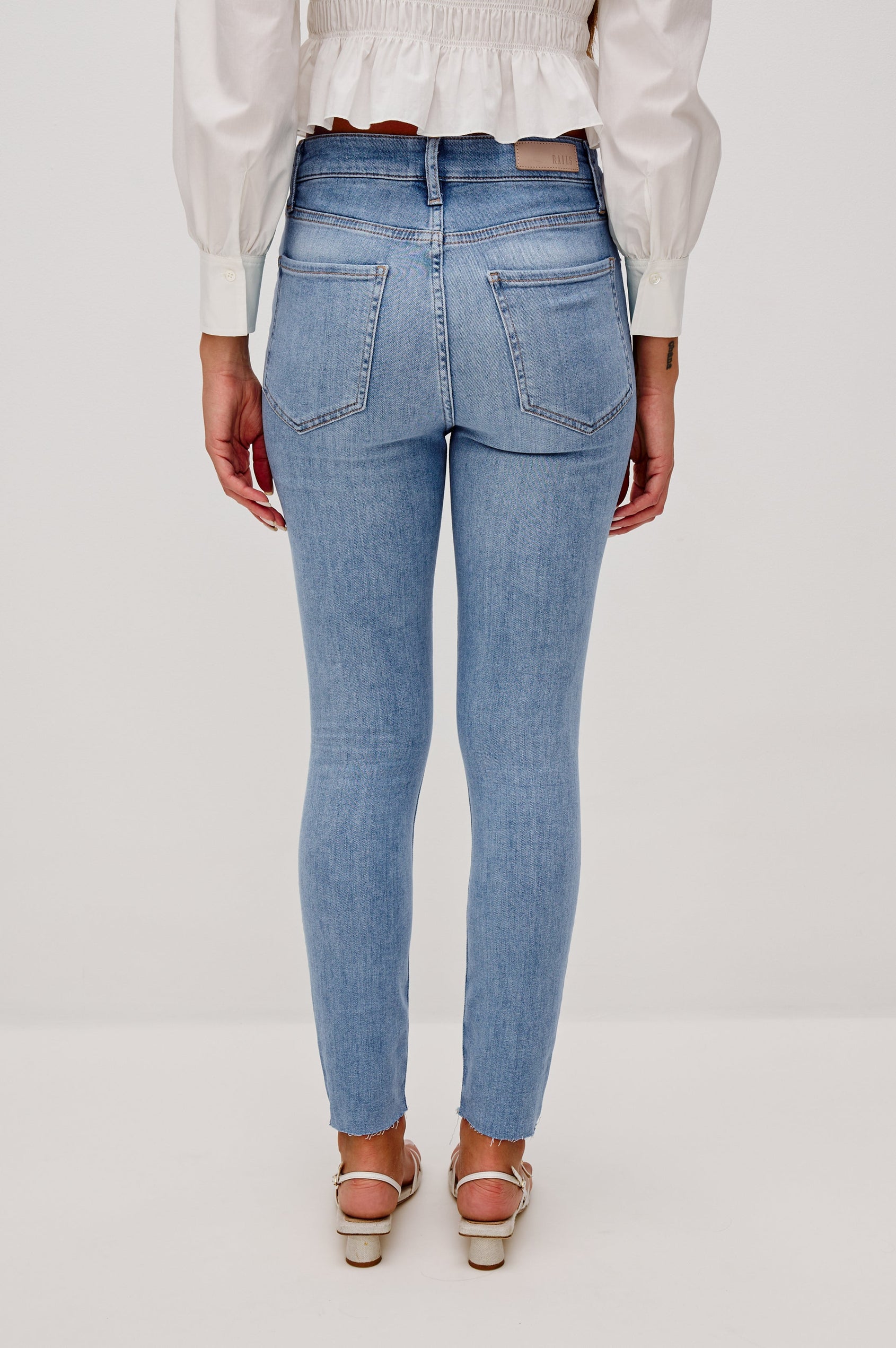 Larchmont 5-pocket skinny jean in medium-light wash tidepool. Full Body Back View Shown on Model.