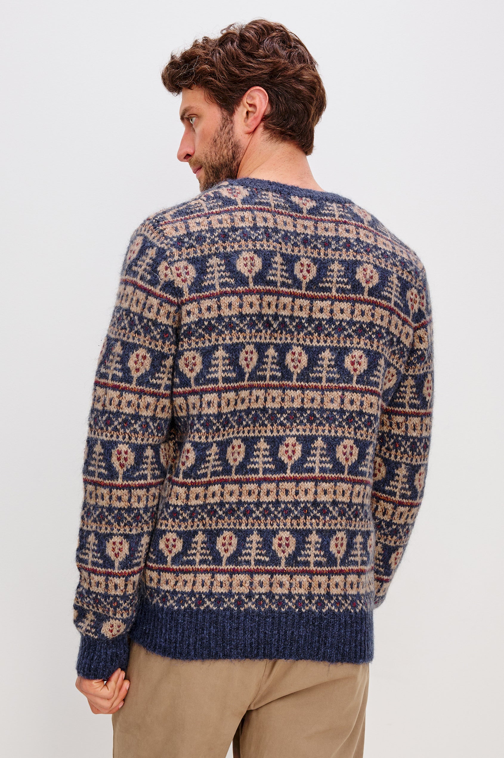 Lars is a relaxed fit crewneck sweater with long sleeves and ribbed trim, Fair Isle motifs in a merino wool blend. Back view featured on model.