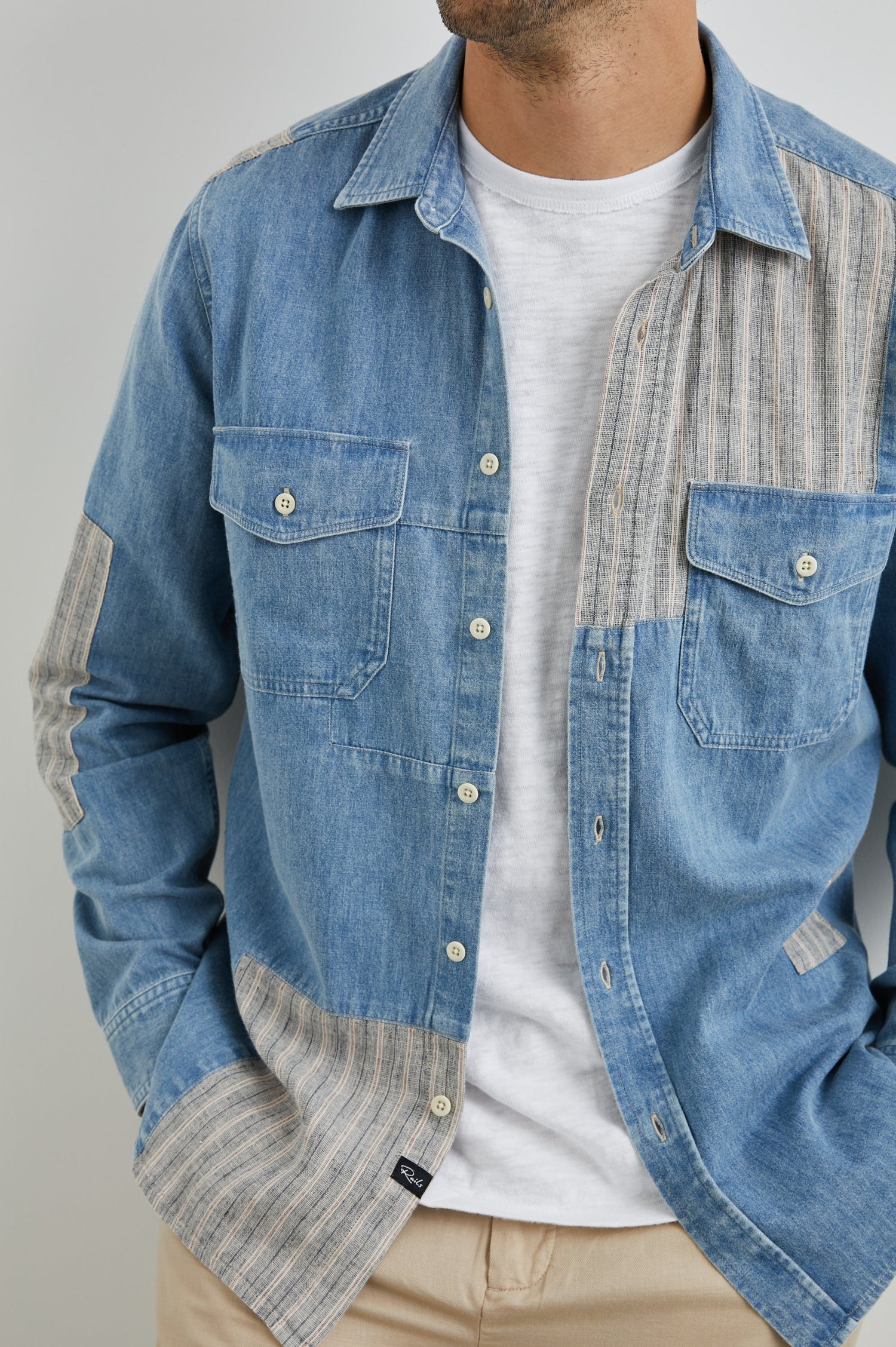 Larsen Long-Sleeve Button Up with Two Chest Button Flap Pockets in Medium Indigo Patchwork Colorway, Denim Patches and Vertical Stripes in Grey and White - Front Unbuttoned View Featured on Model