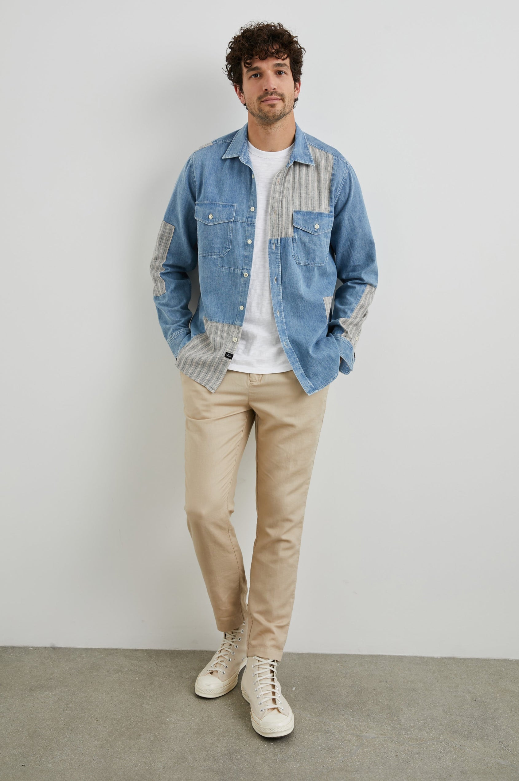 Larsen Long-Sleeve Button Up with Two Chest Button Flap Pockets in Medium Indigo Patchwork Colorway, Denim Patches and Vertical Stripes in Grey and White - Front Unbuttoned Full Body View Featured on Model