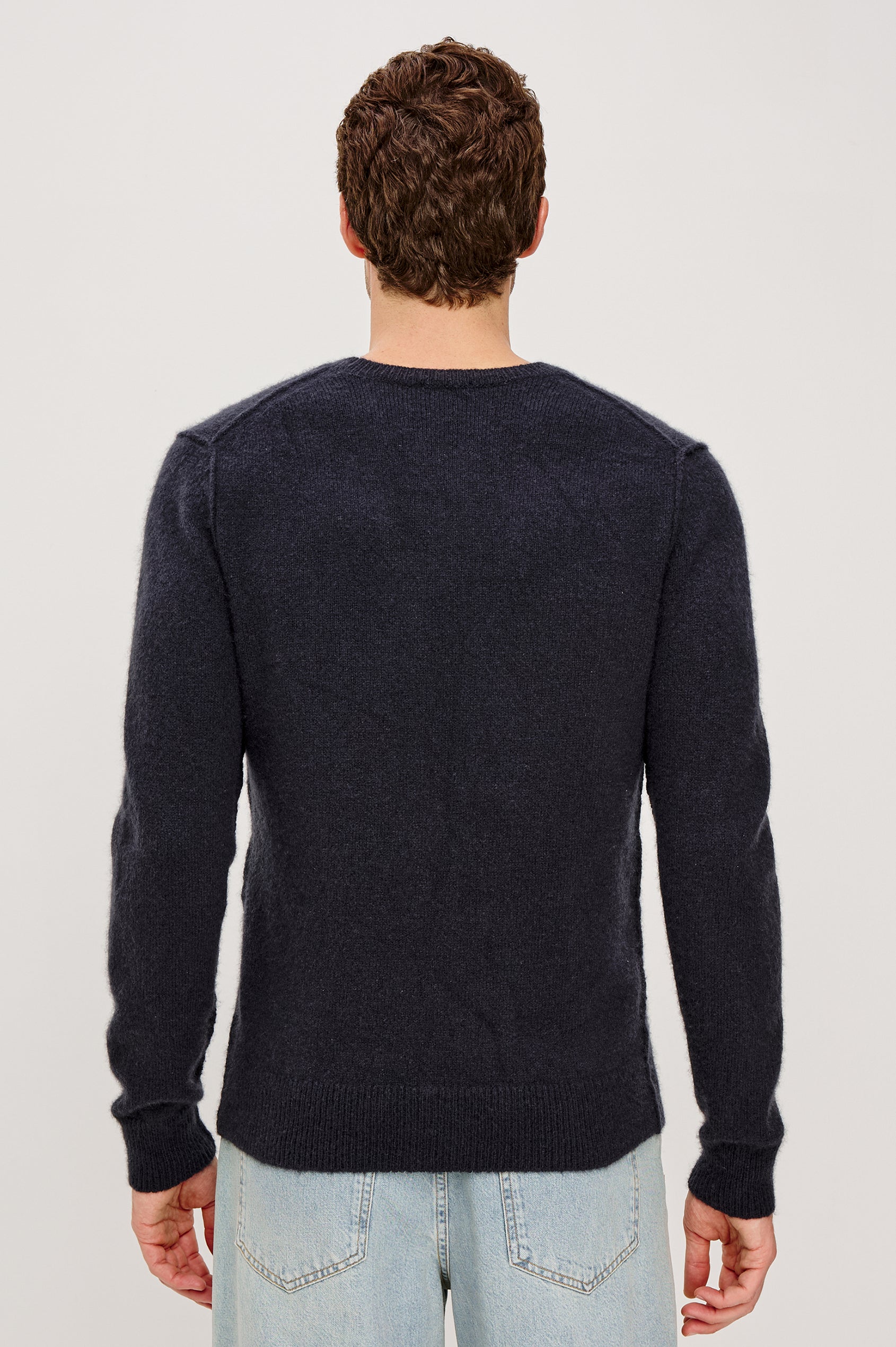 Laurent Crewneck Sweater in Wool Blend With Dropped Shoulders With Linking Stitch Detailing and Long Sleeves in Midnight Colorway - Upper Body Back View Featured on Model