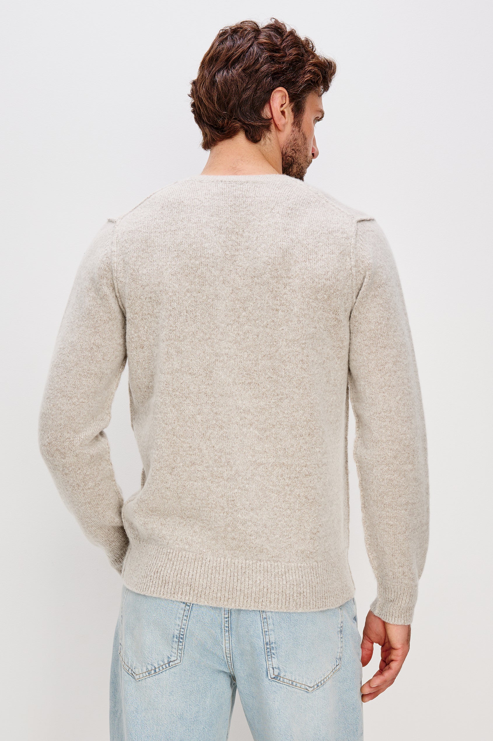 Laurent is a relaxed-fit crewneck sweater, dropped shoulders, long sleeves, and linking-stitch detailing at the shoulders in Silverleaf colorway. Back view featured on model.