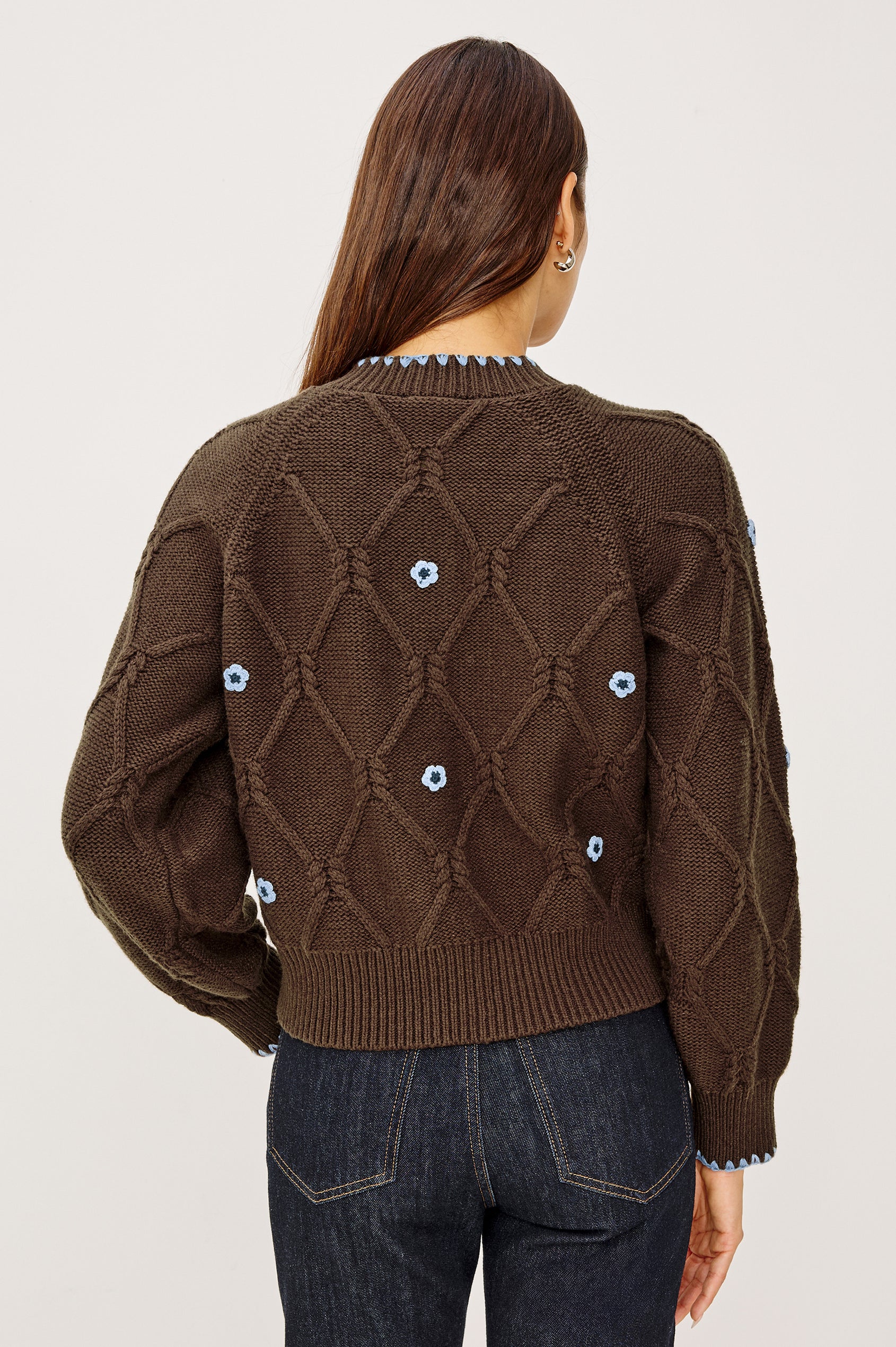 Laurie Cardigan in Cable Knit With Diamond Detailing, Floral Embroidery, Contrast Blanket Stitching, Front Buttons, Long Sleeves, and Ribbed Trim in Walnut Daisy Colorway - Upper Body Back View Featured on Model