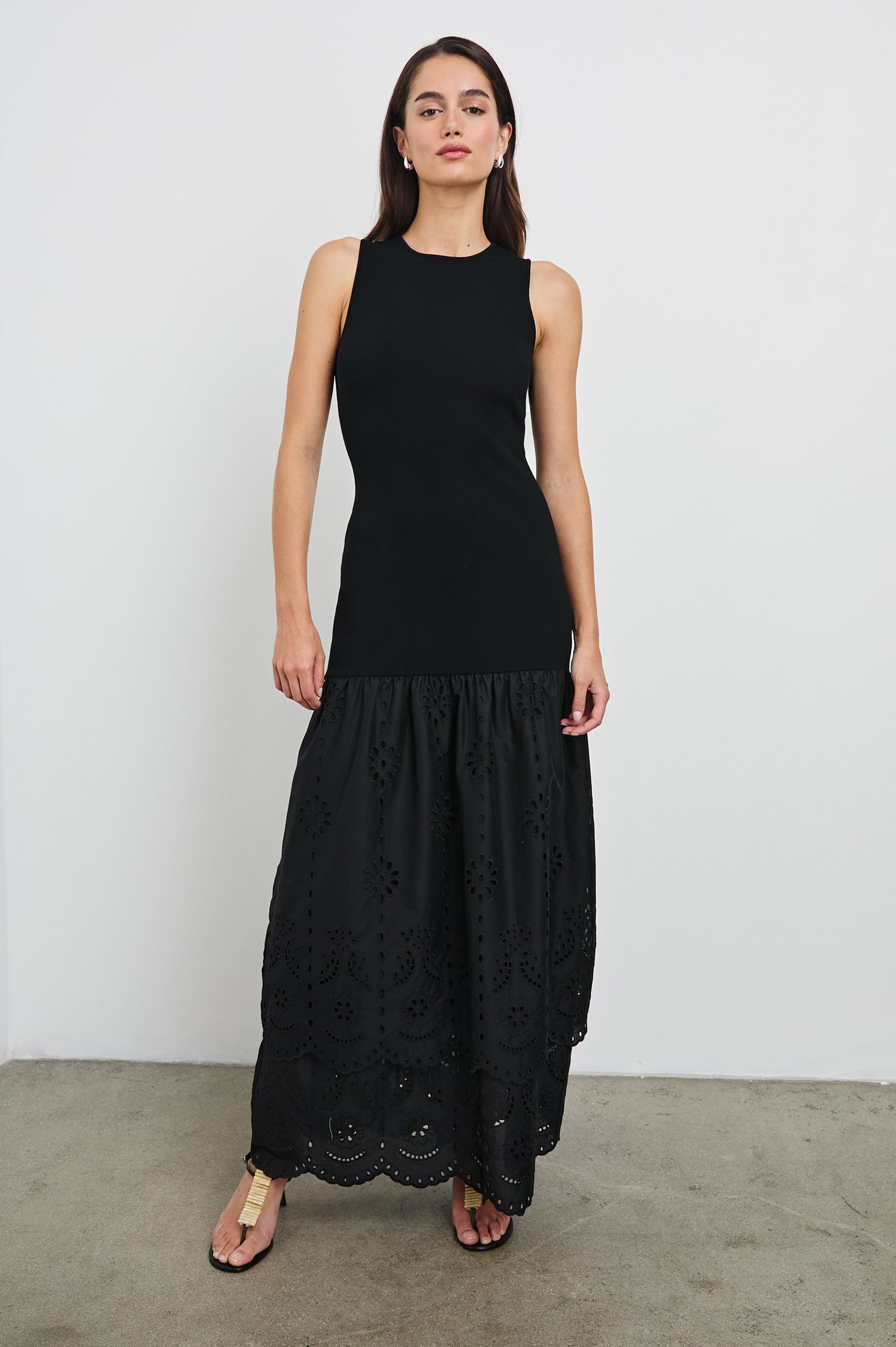 Lavina Crew Neck Tank Maxi Dress with Body Con Fitted Top Half and an Gathered Contrast Fabric Skirt with Embroidered Scallop Two Tier Hem in Black Colorway. Front View Shown on Model.