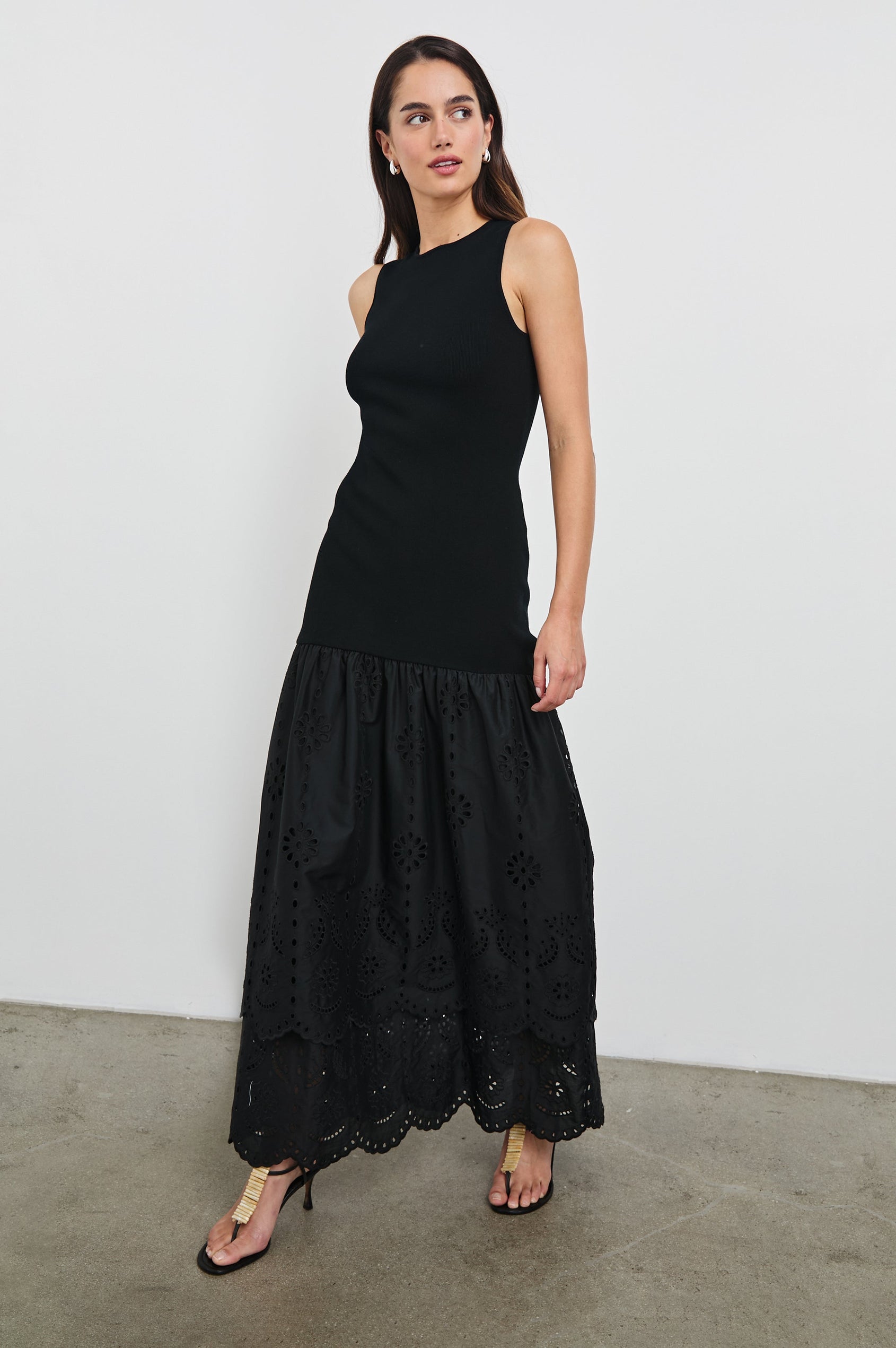 Lavina Crew Neck Tank Maxi Dress with Body Con Fitted Top Half and an Gathered Contrast Fabric Skirt with Embroidered Scallop Two Tier Hem in Black Colorway. Front View Shown on Model.