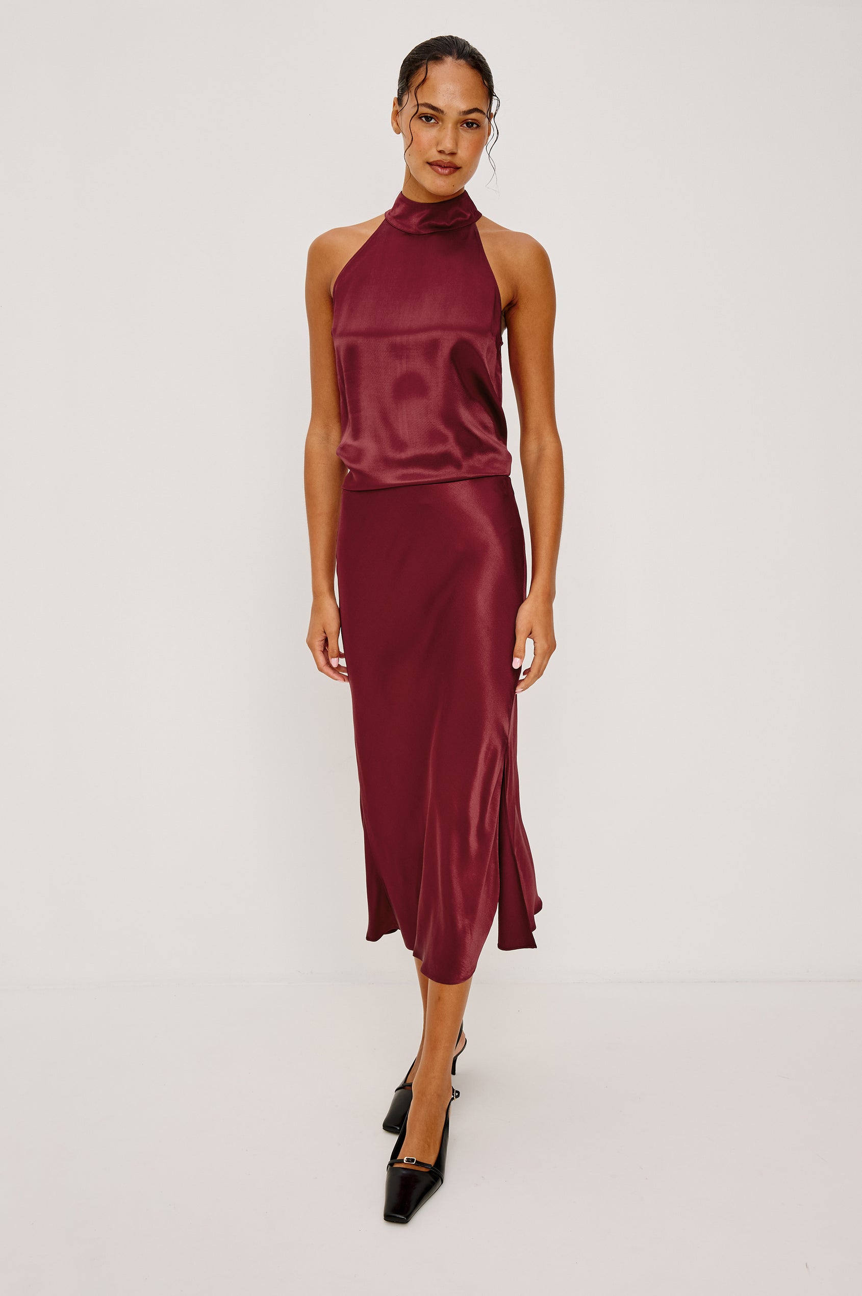 Leah Halter Top in Satin Crepe With a High Neckline, Sleevleless Cut, Back Button Neck Closure in Garnet Colorway - Full Body Front View Featured on Model