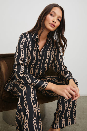 Ledger Long-Sleeve Button Down in Black Gold Link Colorway, vertical gold links on black - Front View Featured on Seated Model