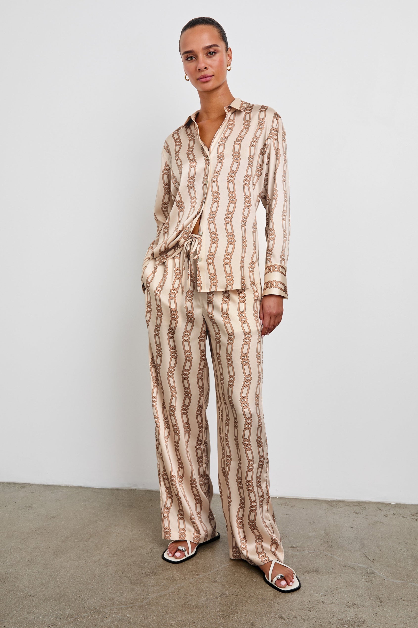 Ledger Long-Sleeve Button Down in Ivory Gold Link Colorway, vertical gold links on tan - Front Full Body View Featured on Model