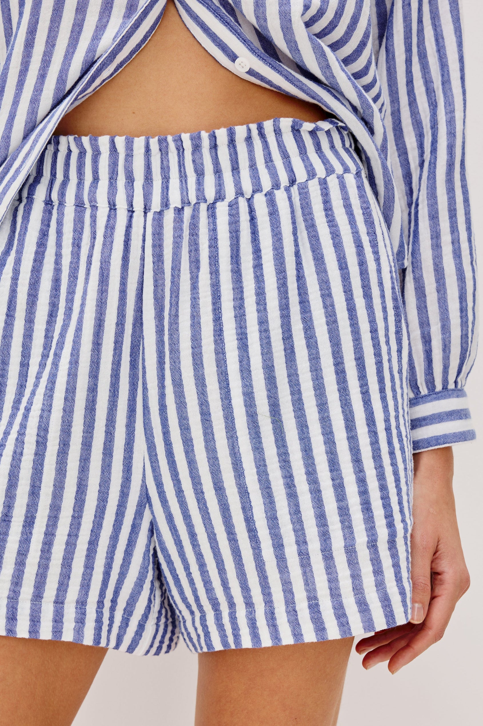 Leighton Shorts with Textured Fabric, a Smocked Elastic Waist, and Large Front Pockets in Anacapa Stripe Colorway, Blue and White Vertical Stripe - Front Detailed View Featured on Model